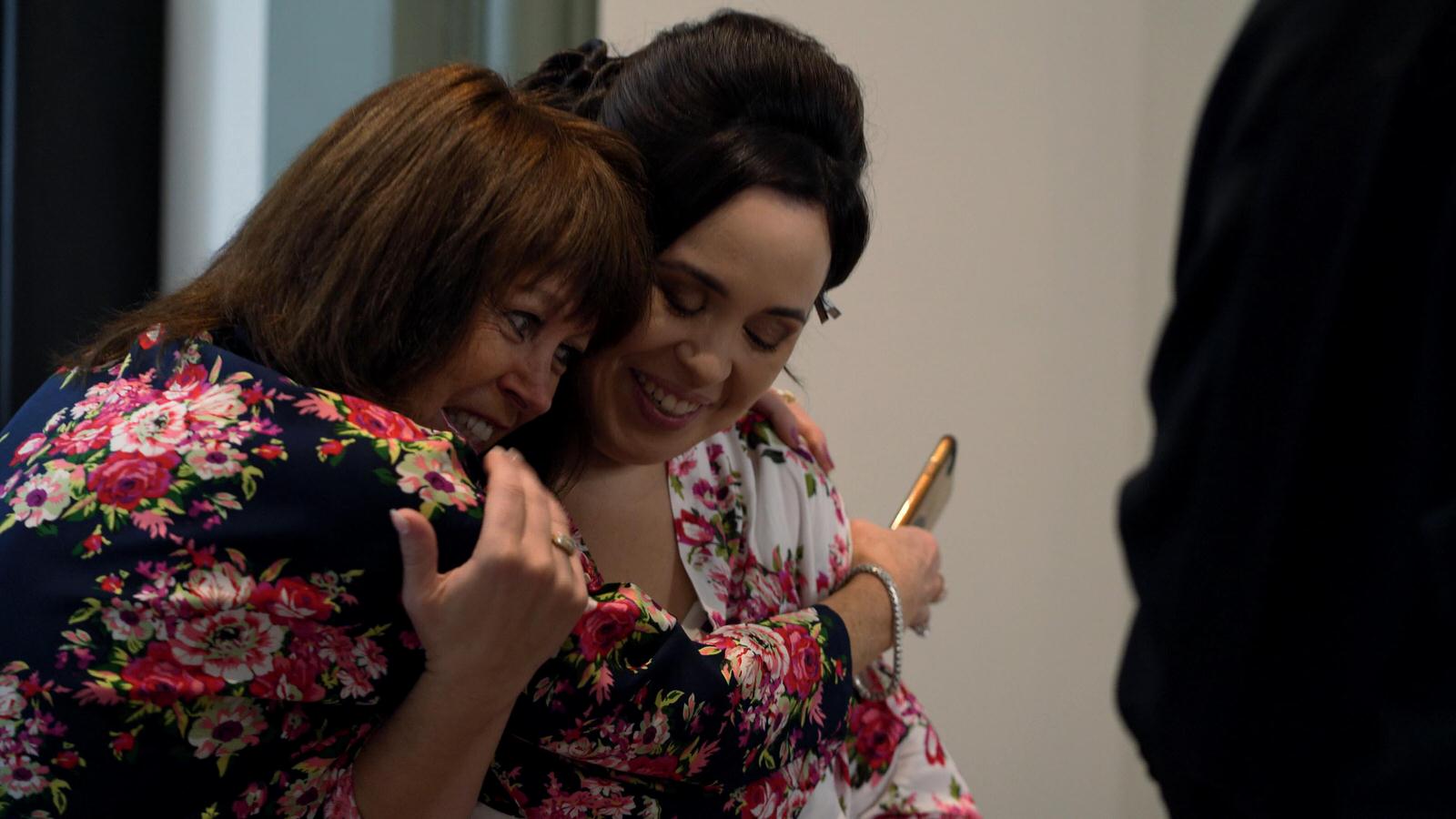 mum squeezes daughter on her wedding morning