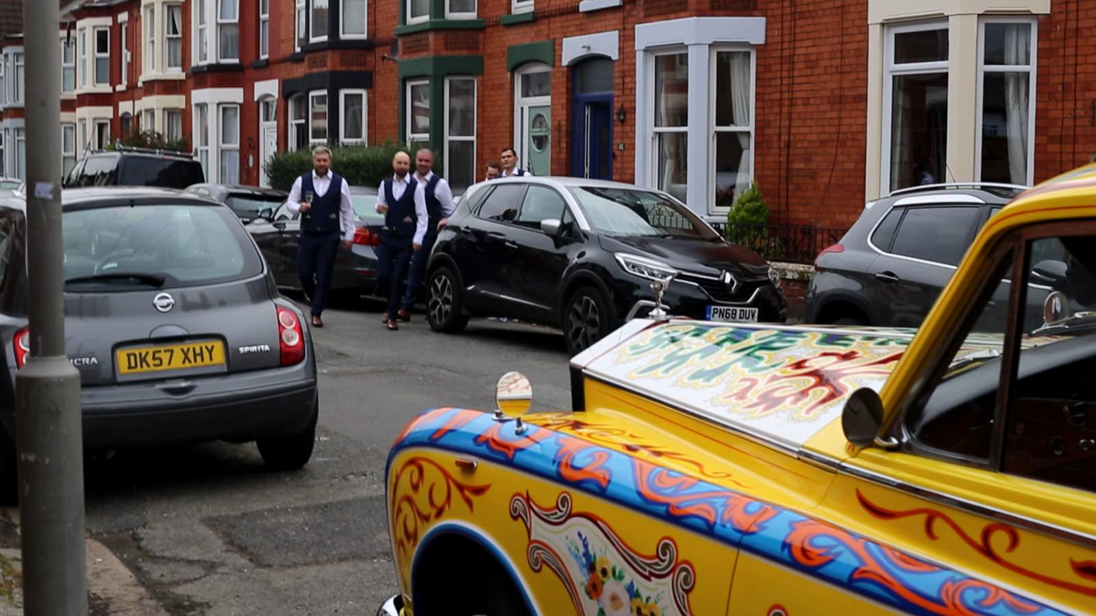 groom shows off wedding car to groomsmen