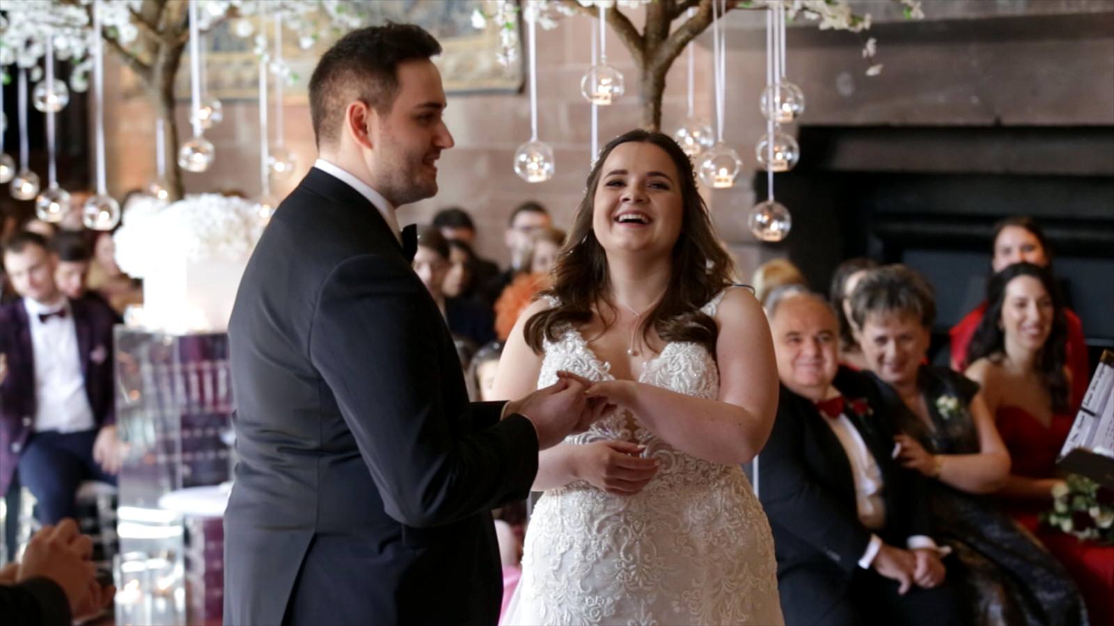 couple laugh during wedding ceremony in the great hall