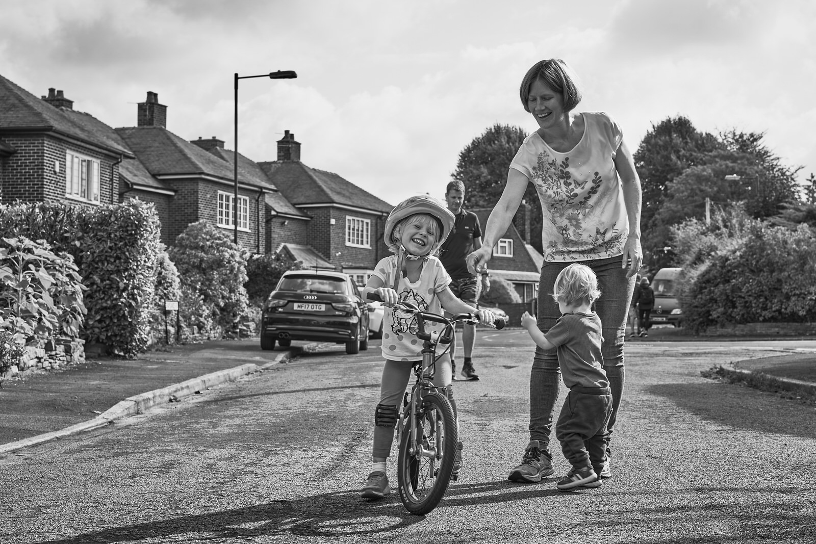 family laugh together on their road during family photoshoot