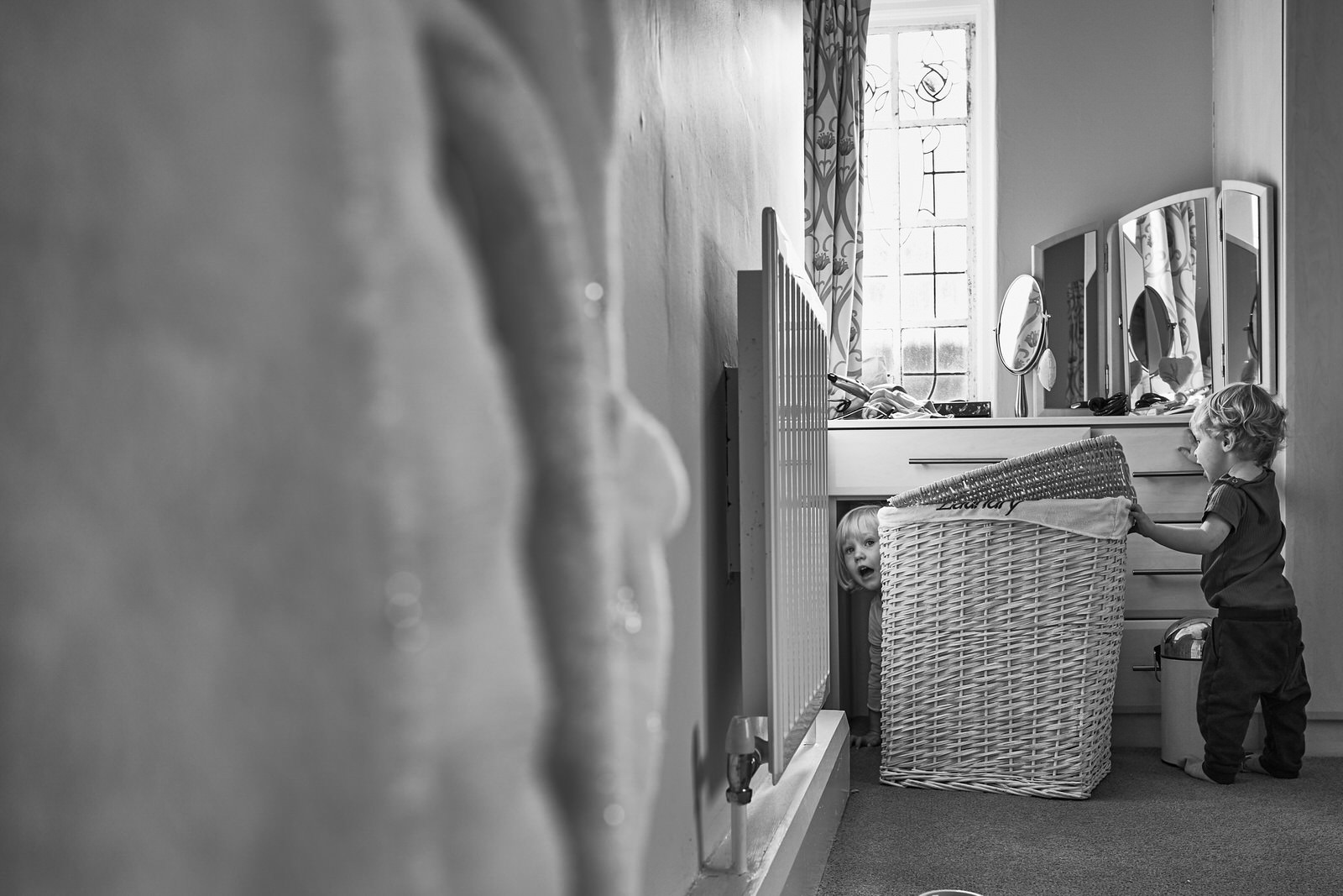 children play hide and seek in parents bedroom