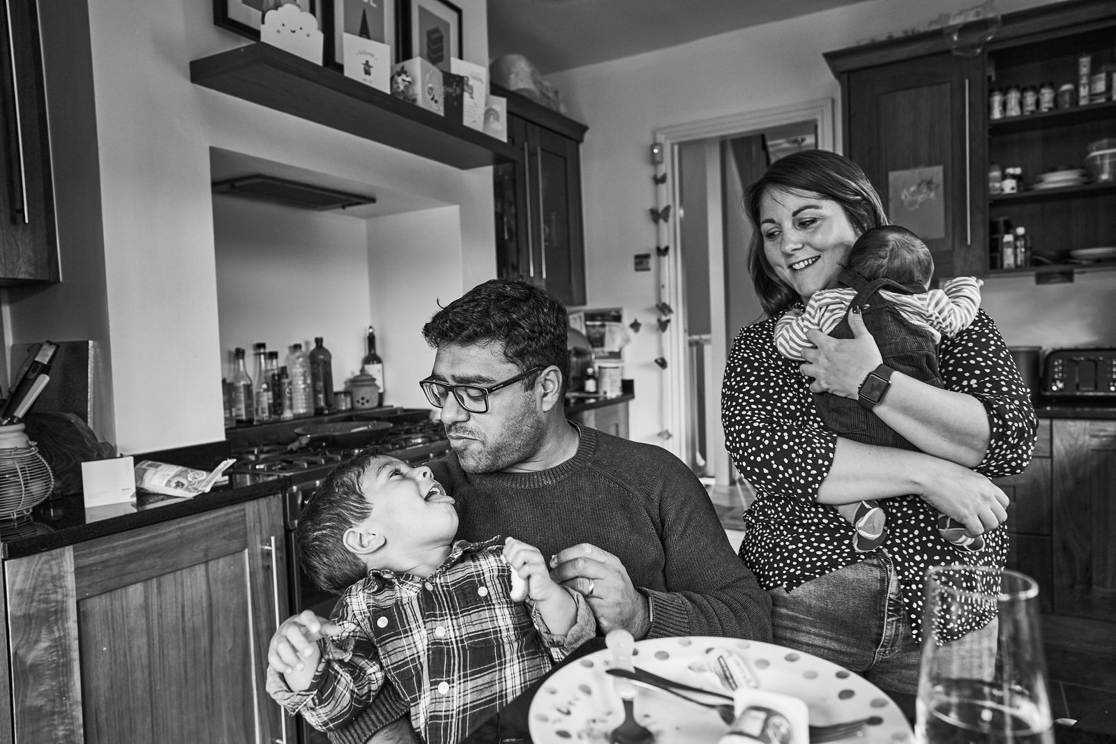 family laugh together during family photo shoot in manchester