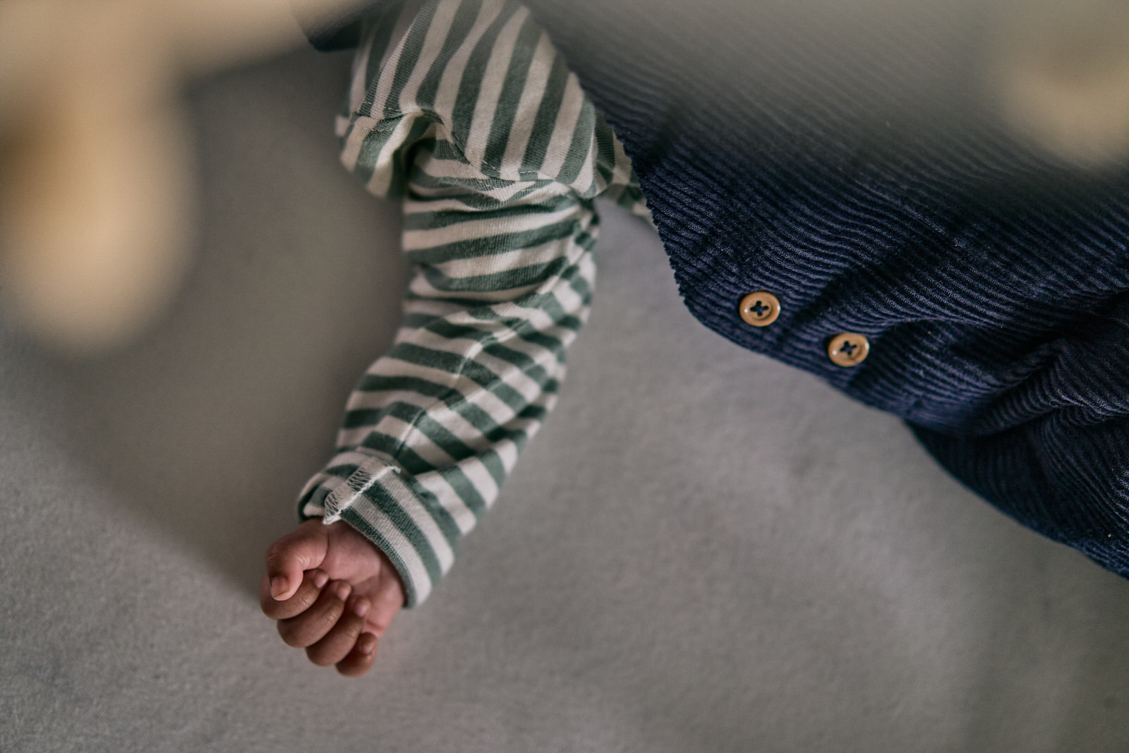 photo of newborn baby hand in cot