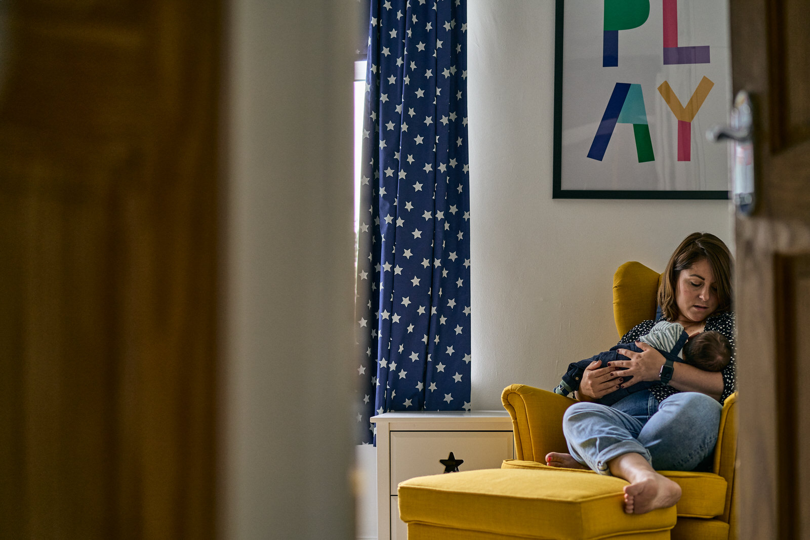 natural photo of mother sat in nursery with baby