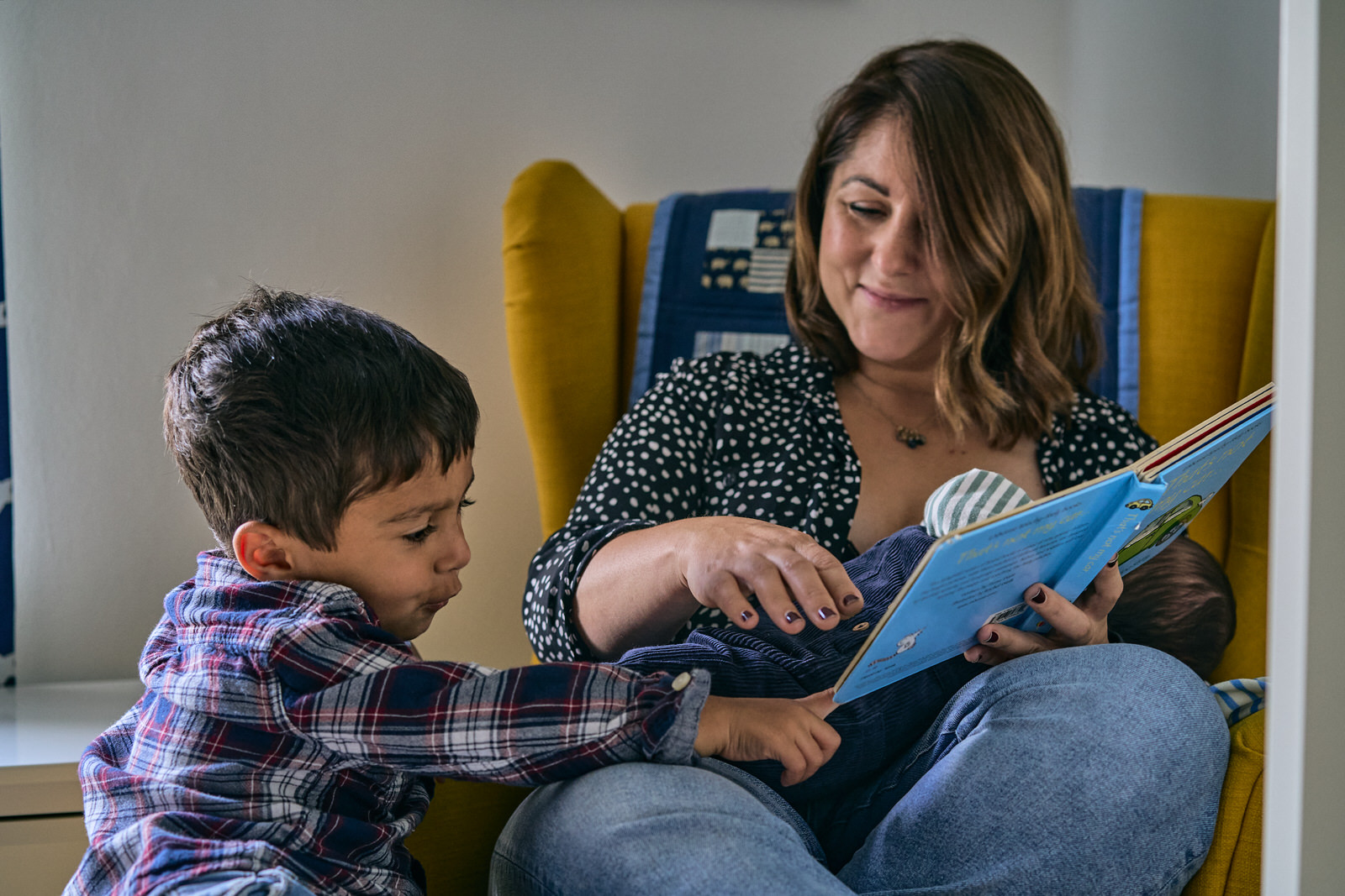mum reads to toddler whilst feeding