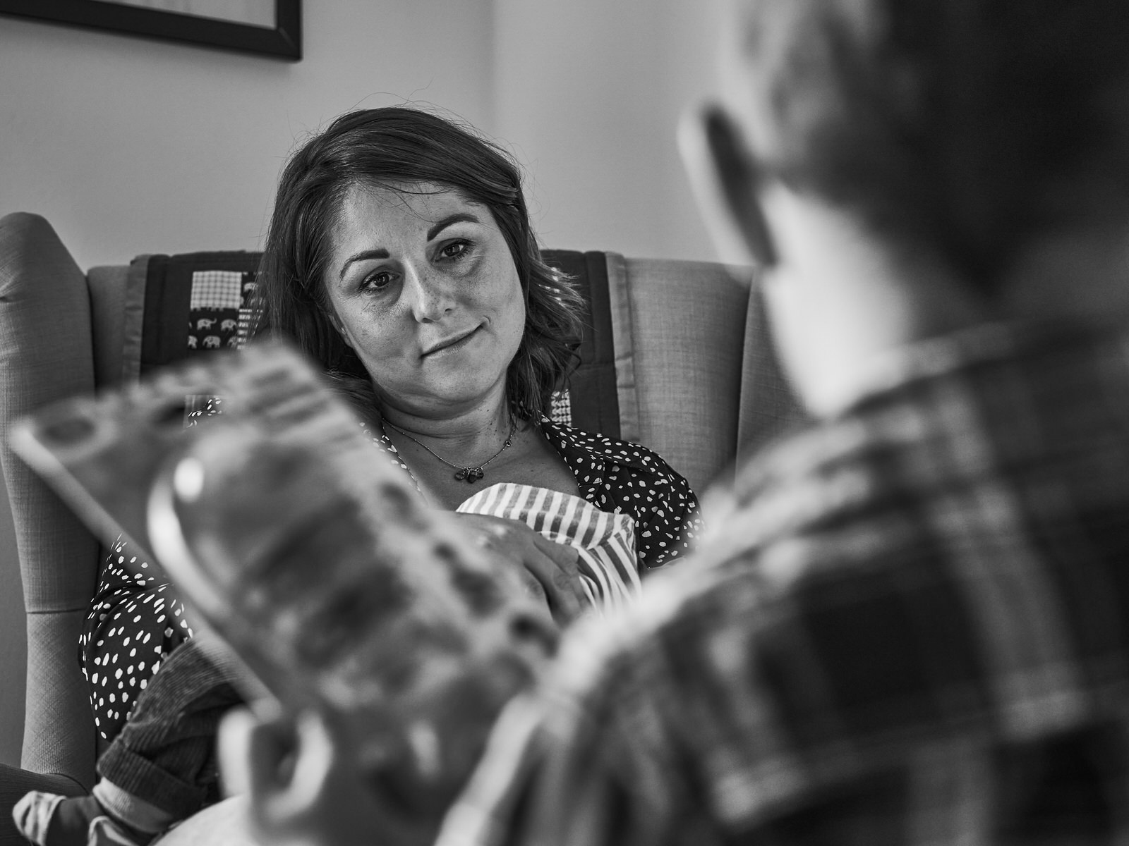 natural moment of mum smiling at son at home in manchester