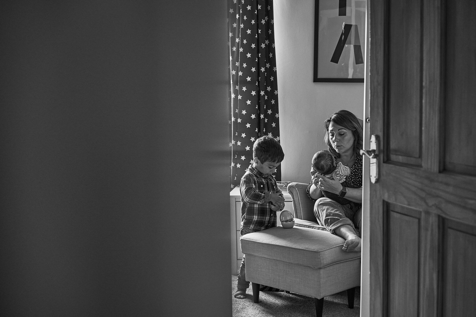 A candid photo of a mother and young children in their nursery in Sale Manchester