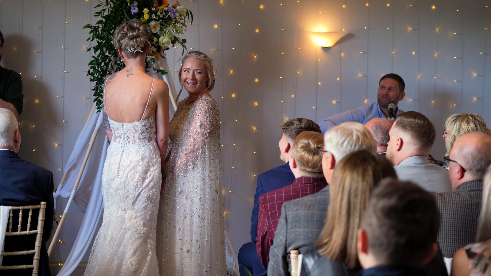 bride smiles at her guests during ceremony