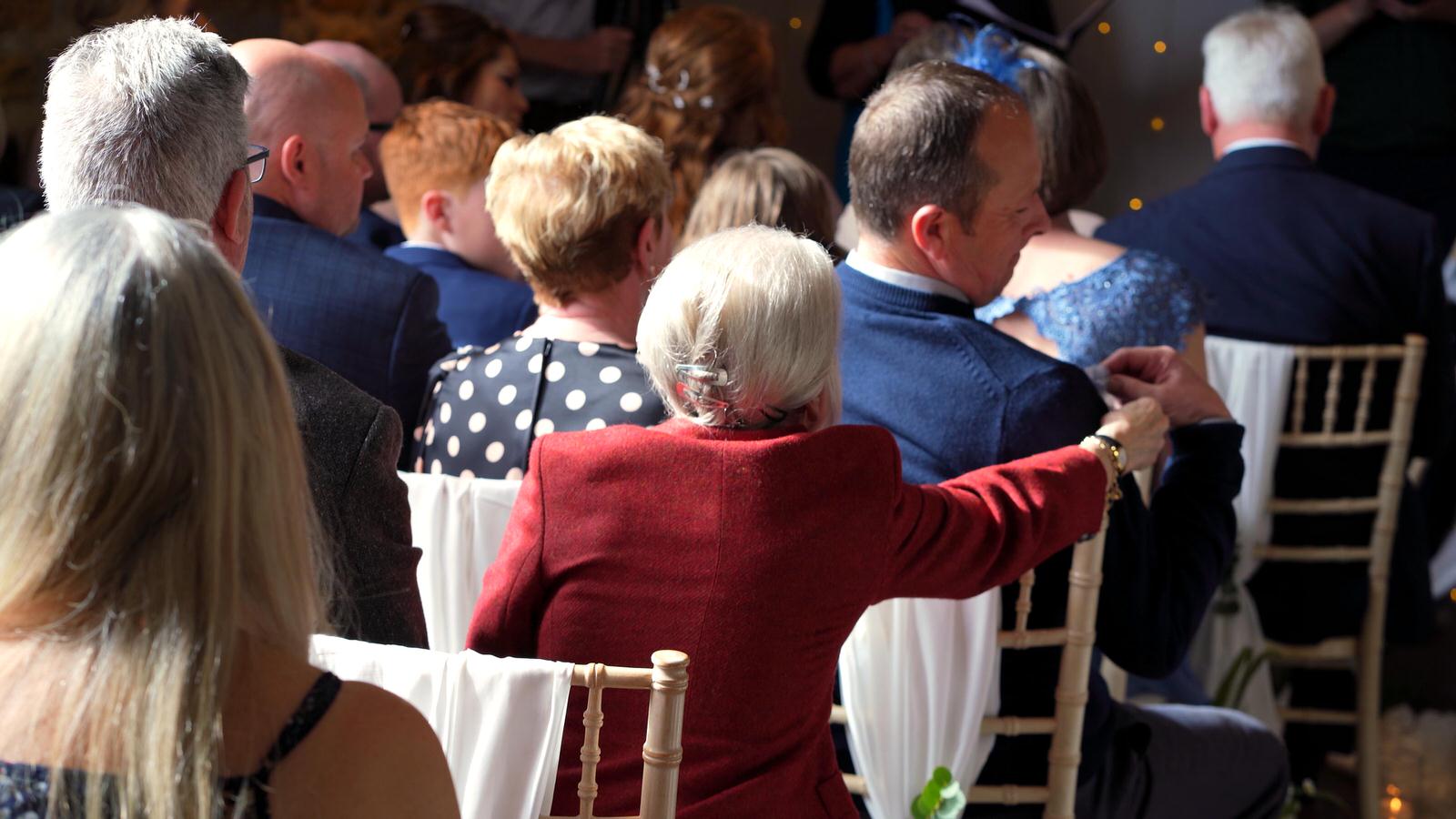guests pass the wedding rings round for ring warming