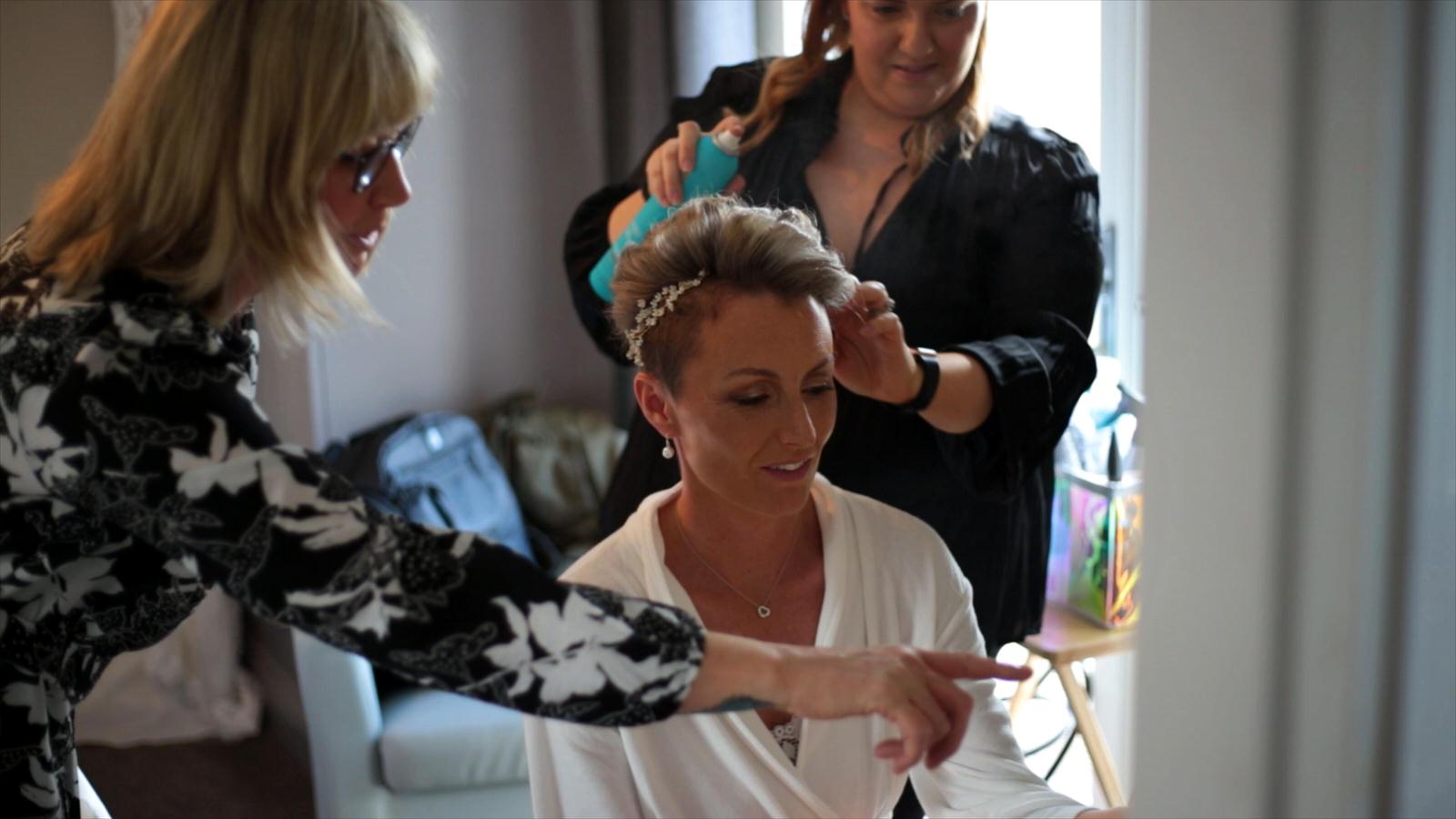 bride getting short hair styled for wedding