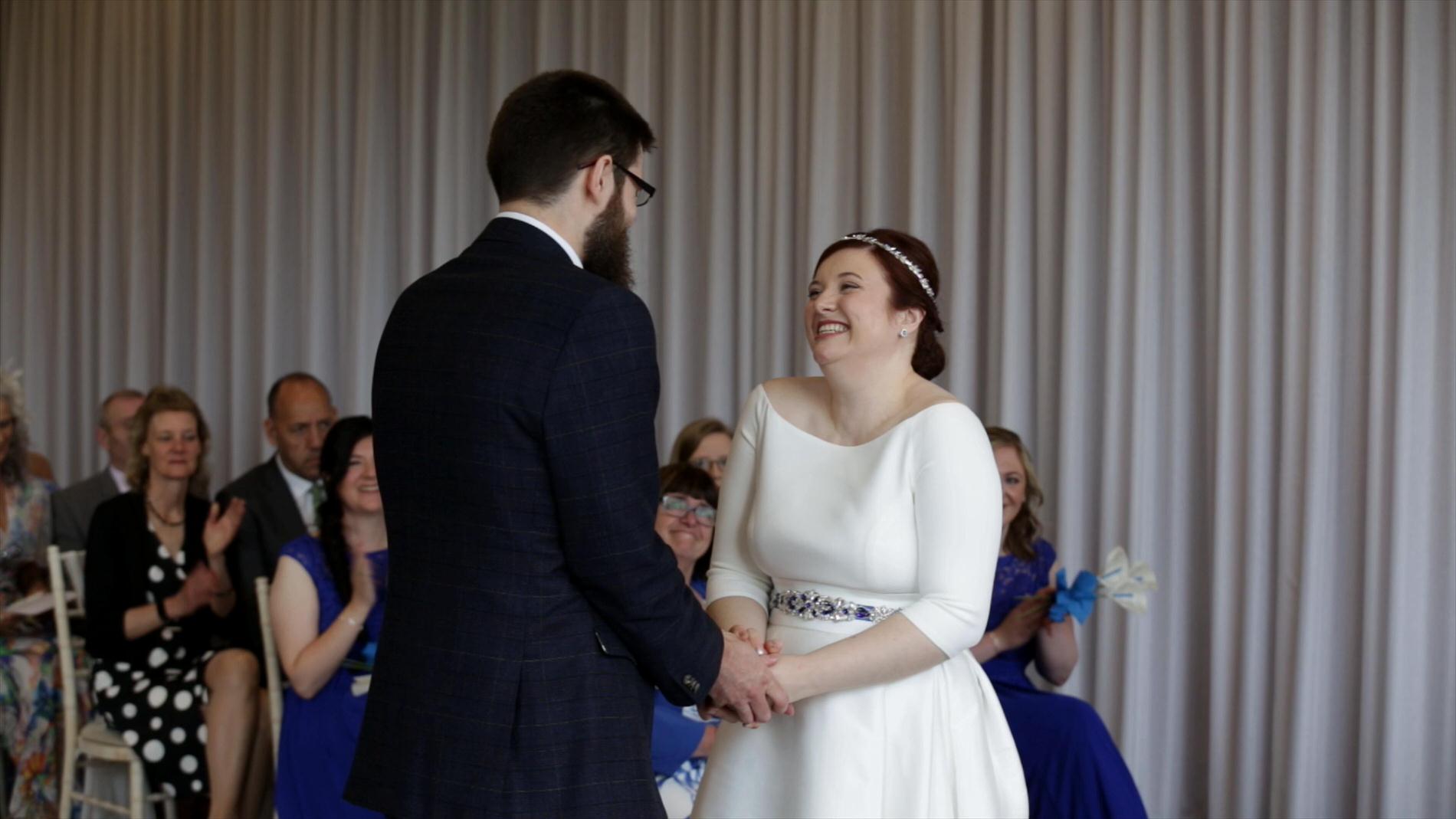 bride and groom grin at each other