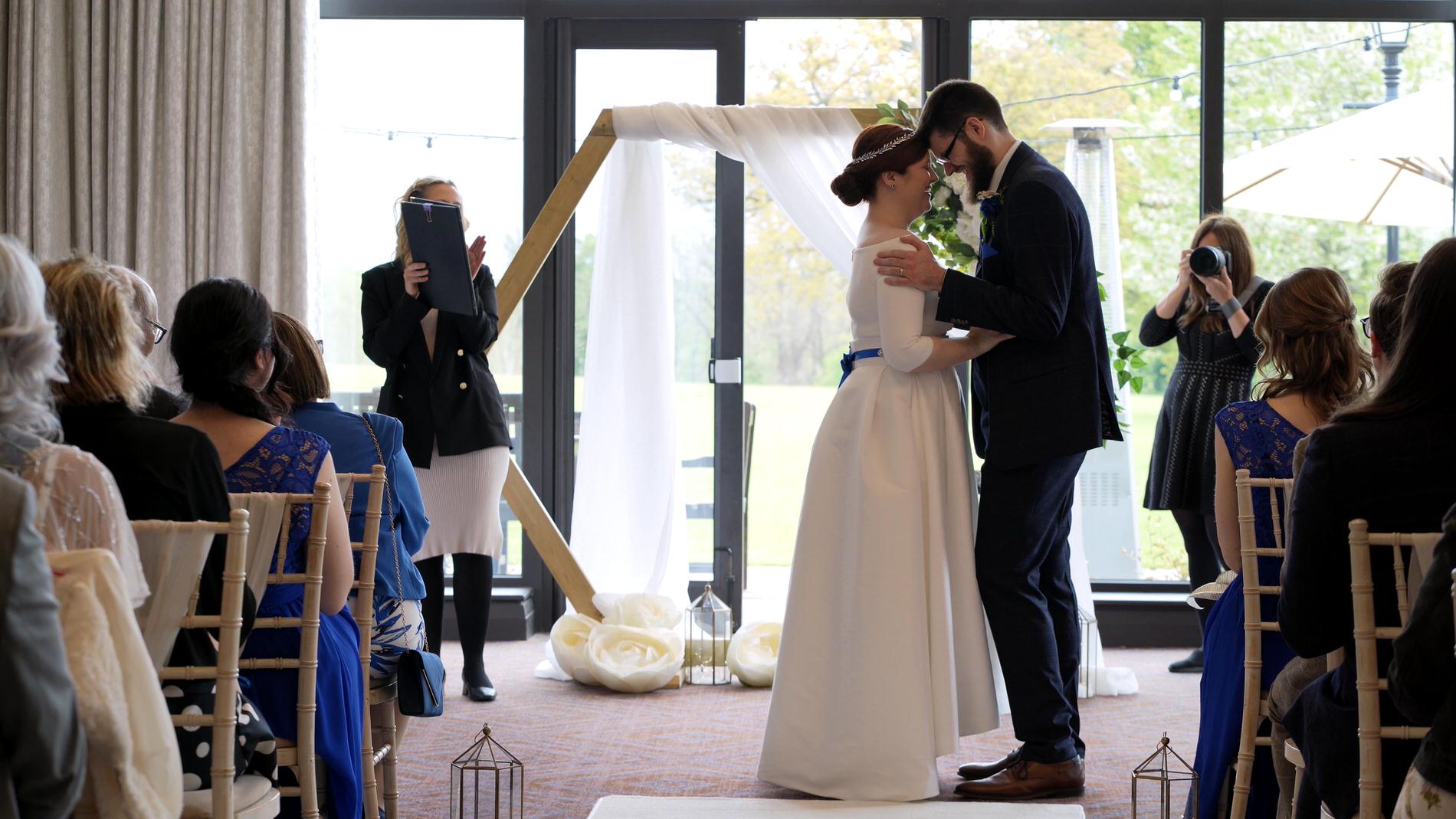 couple snuggle during ceremony