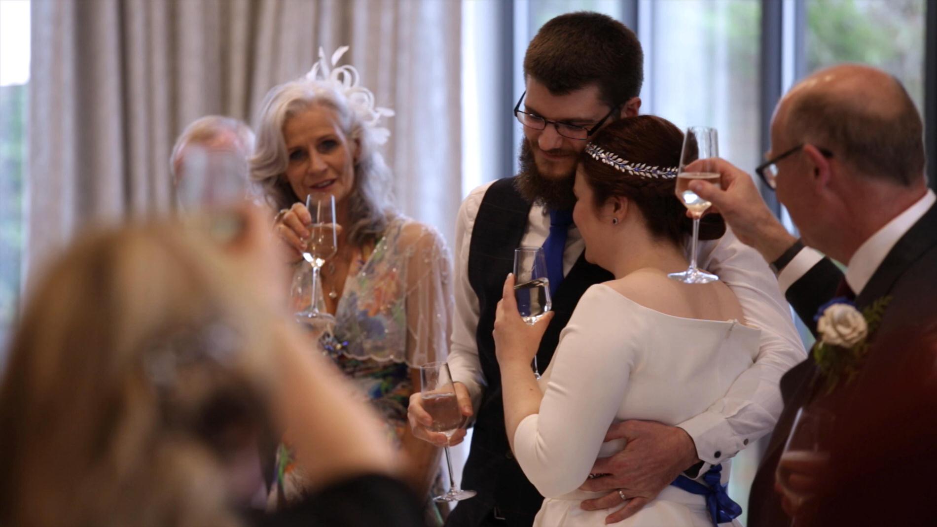 couple hug during wedding toasts