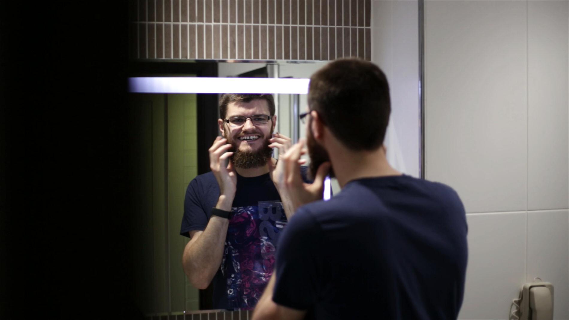 groom perfects his beard at wedding