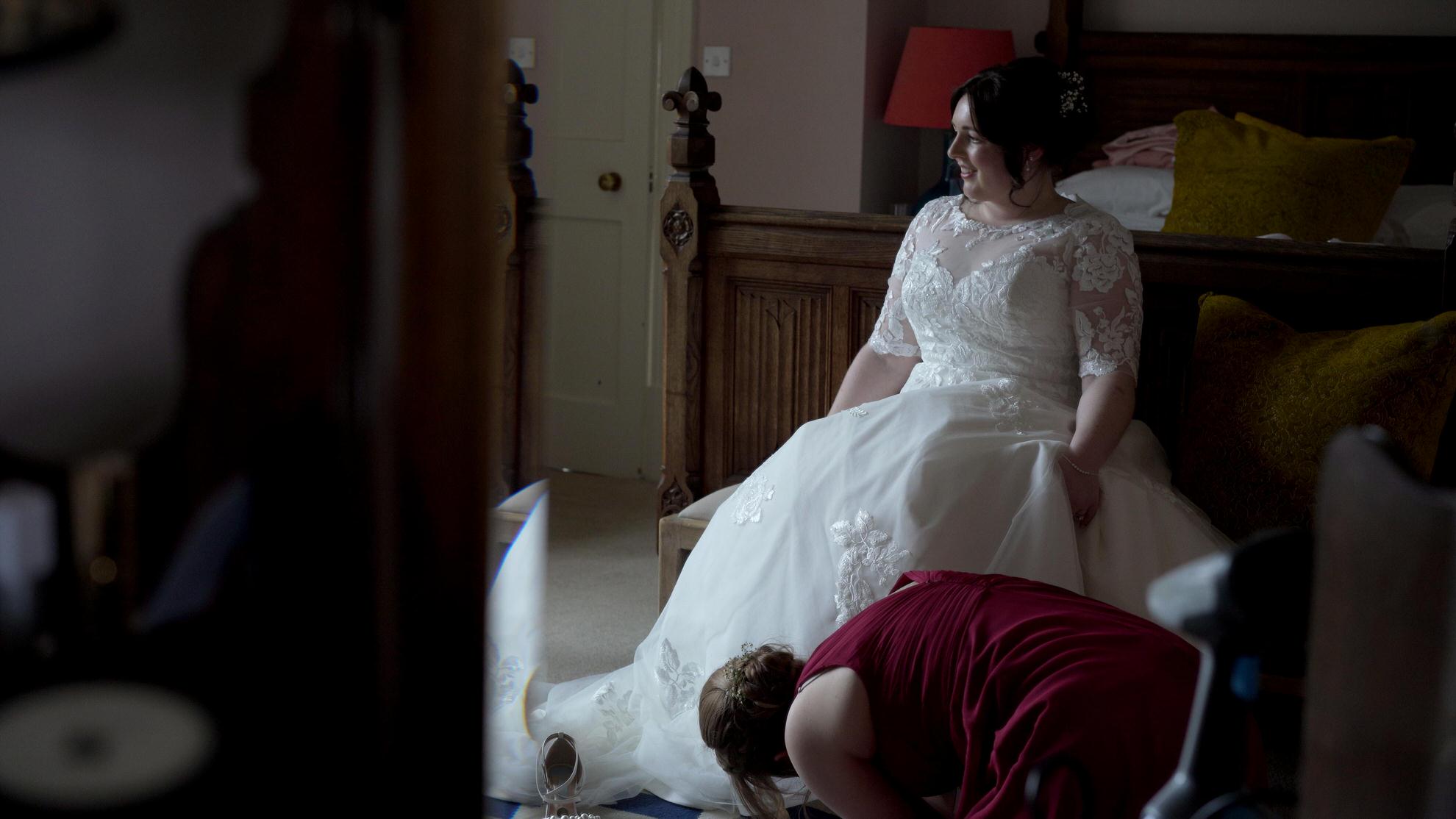 natural light video still of bride sitting in her wedding dress at Wyresdale Park