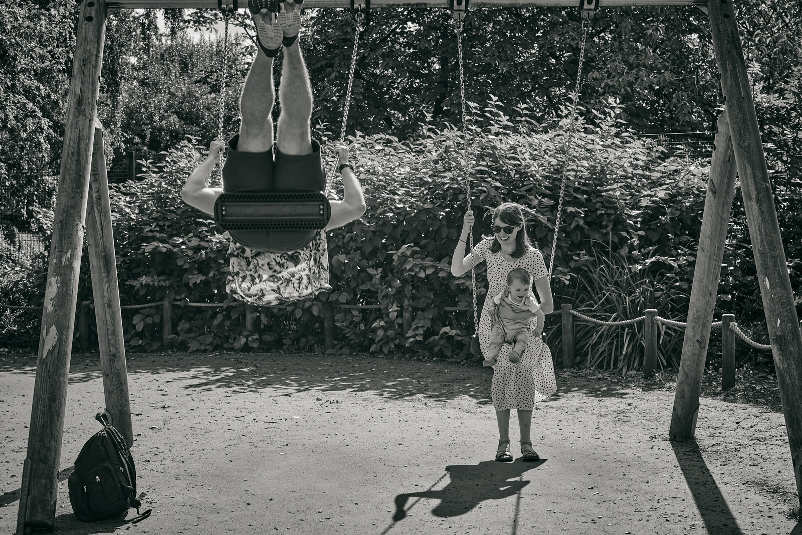 dad swings alongside baby at the park in walkden