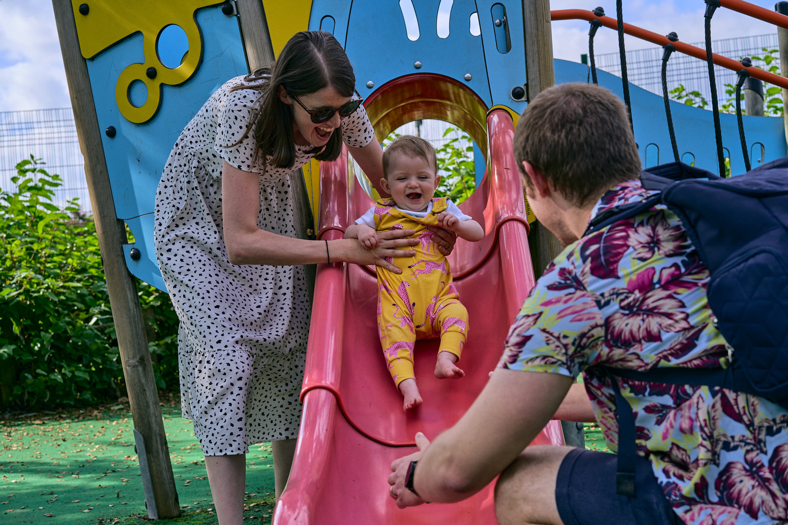 fun photo of family playing on the slide