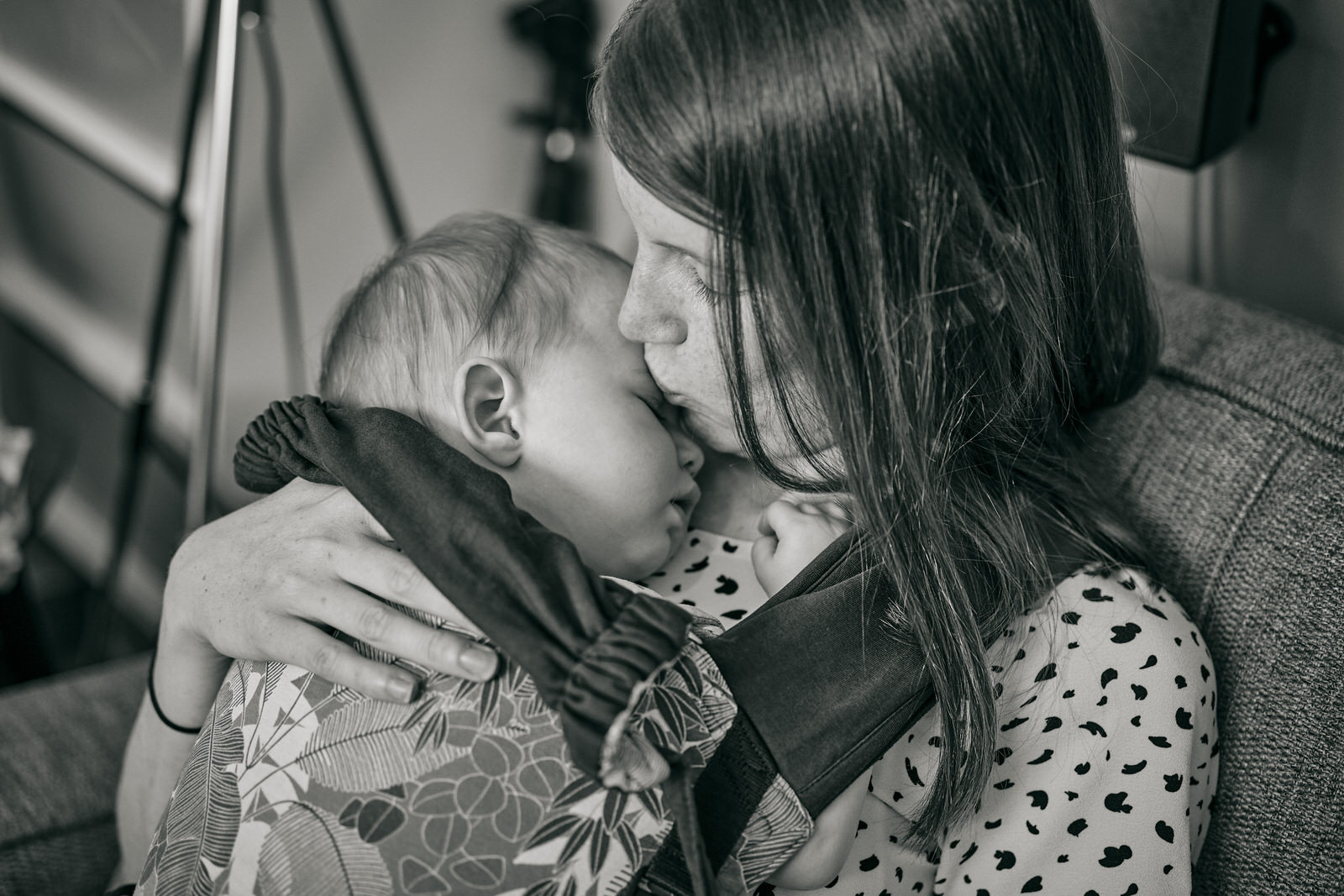 natural photo of mum kissing sleeping baby