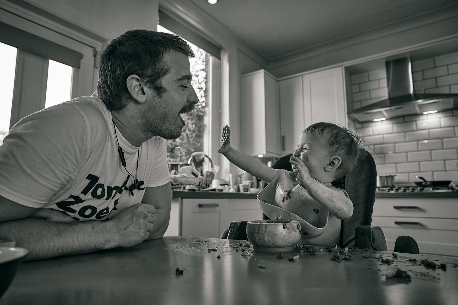 dad and baby play during family meal