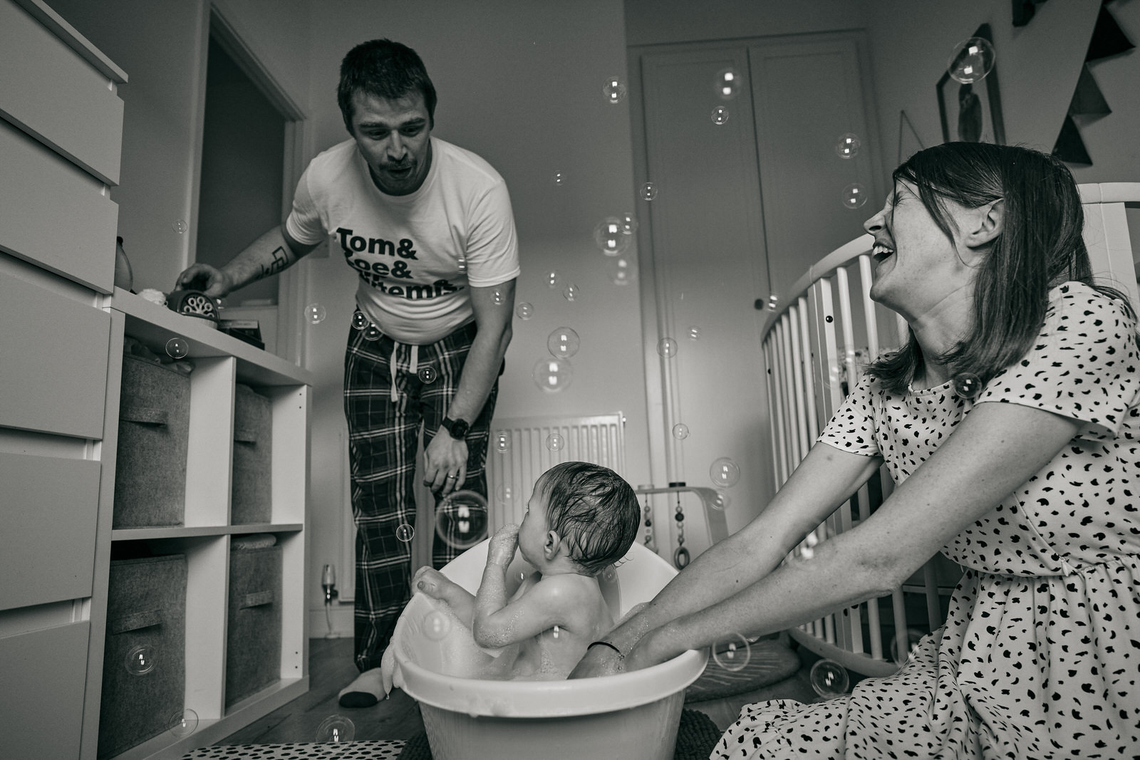 family play with bubbles during bathtime