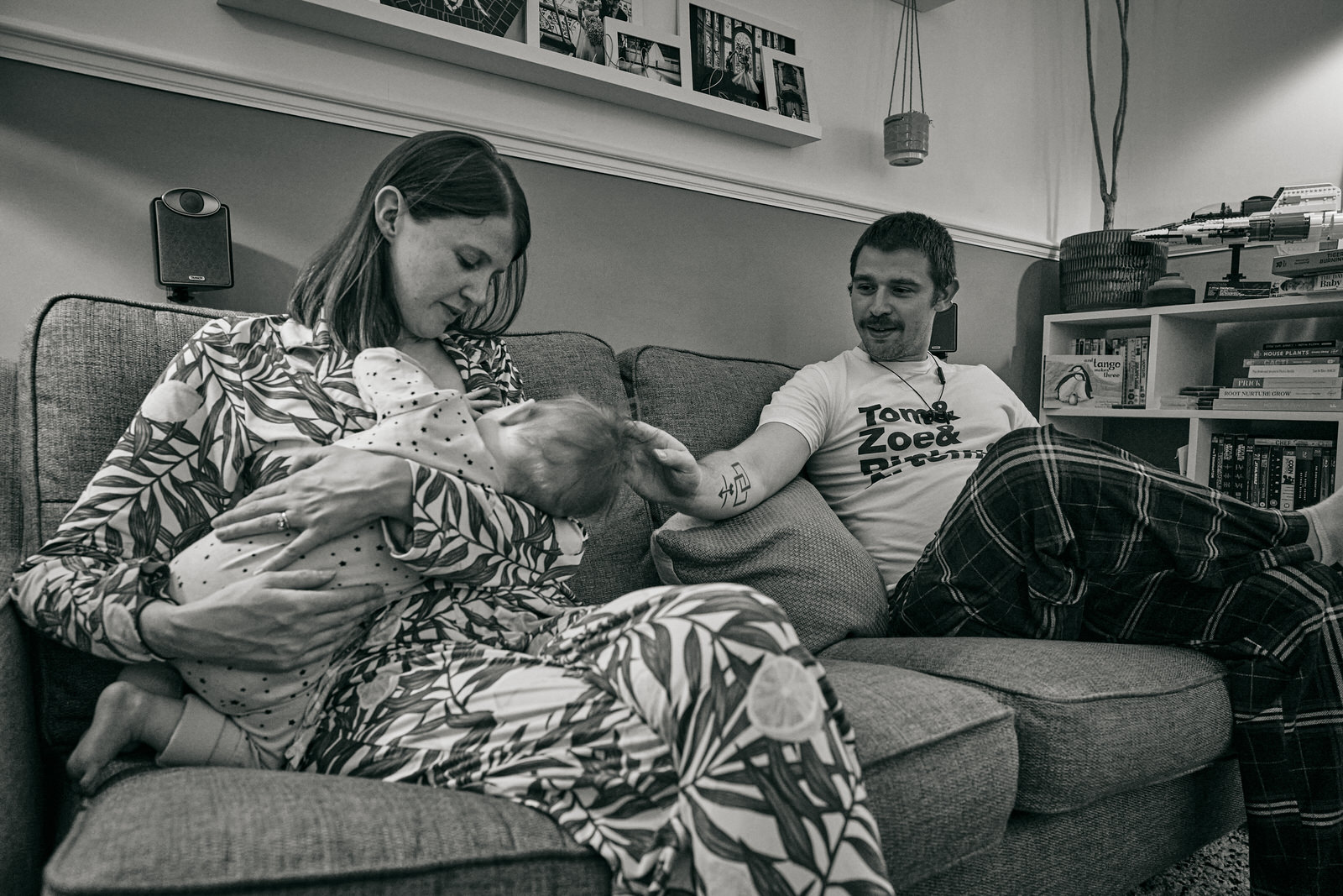 natural photo of mum breastfeeds baby to sleep next to dad