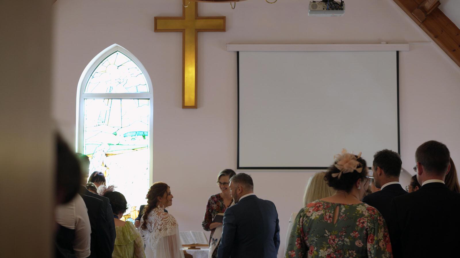 a video still of a wedding ceremony at Midge Hall Methodist church