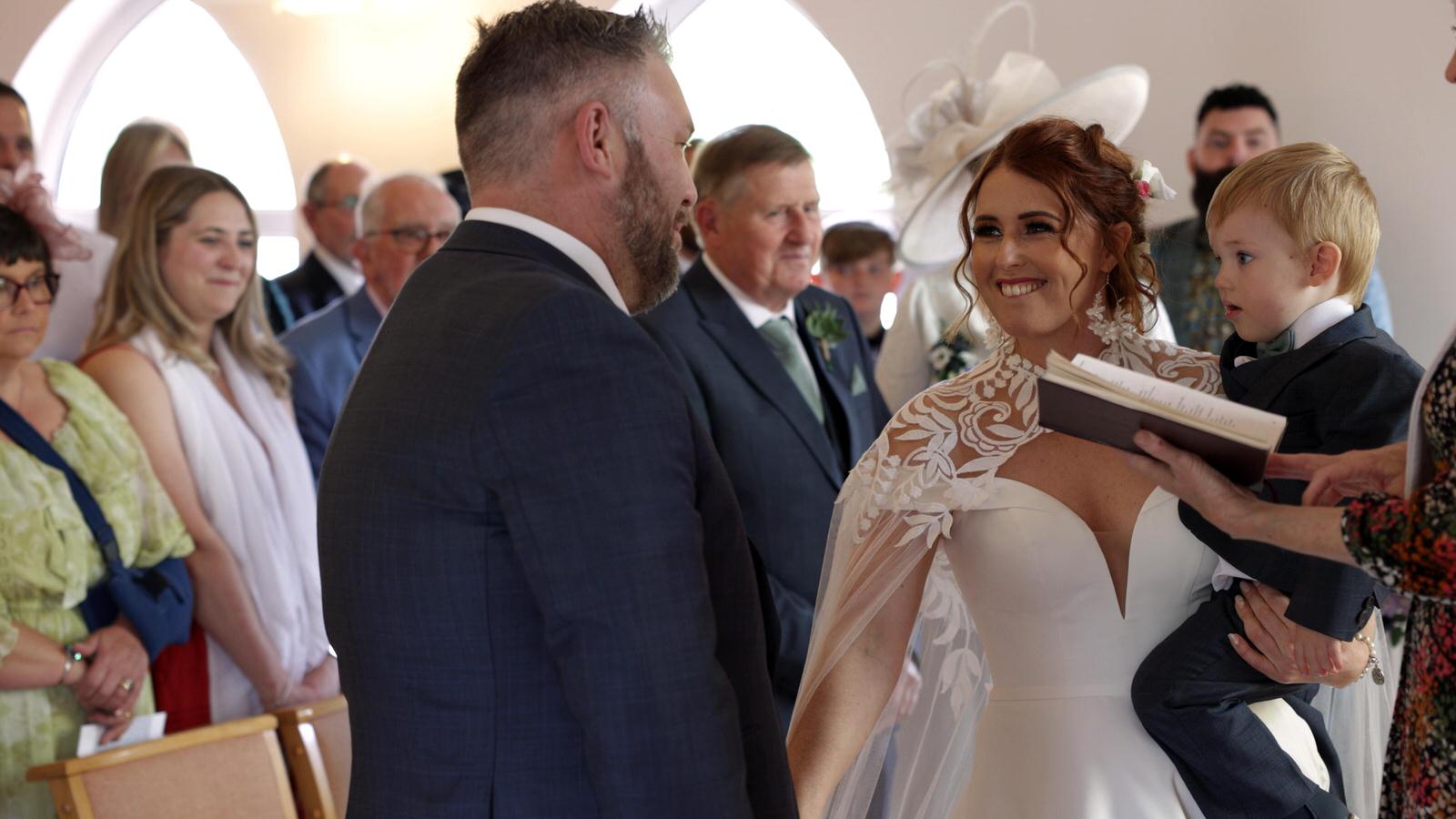 the bride holds her son as they say their vows