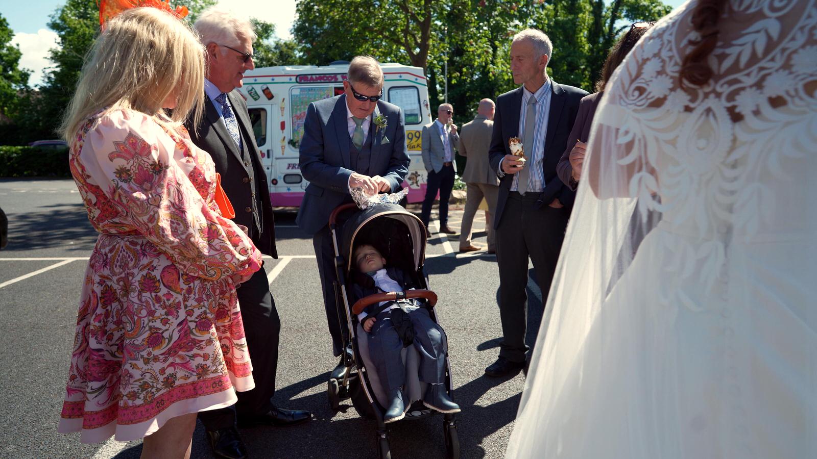 wedding guests mingle outside Mawdesley village hall
