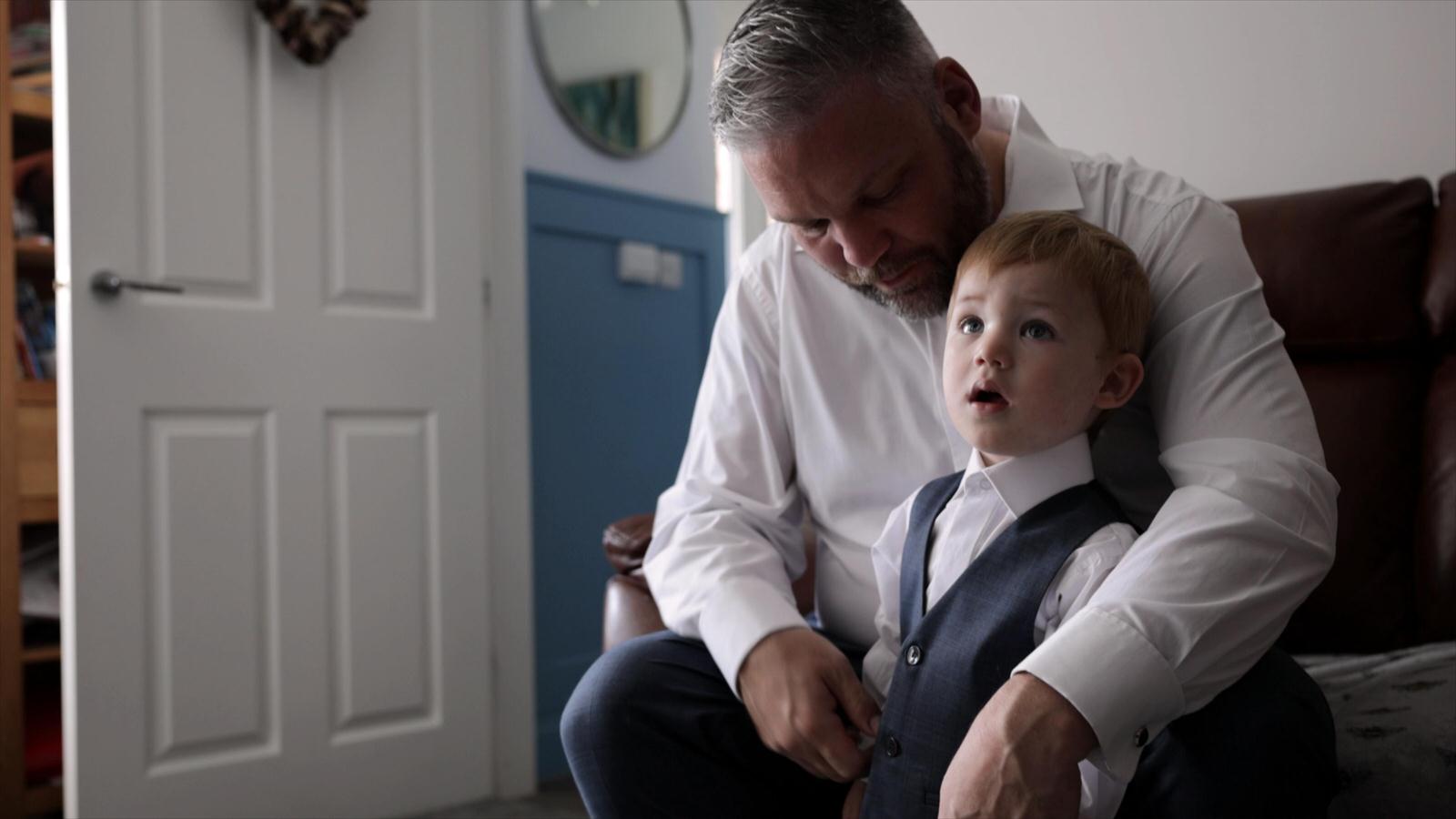 the page boy has help getting dressed