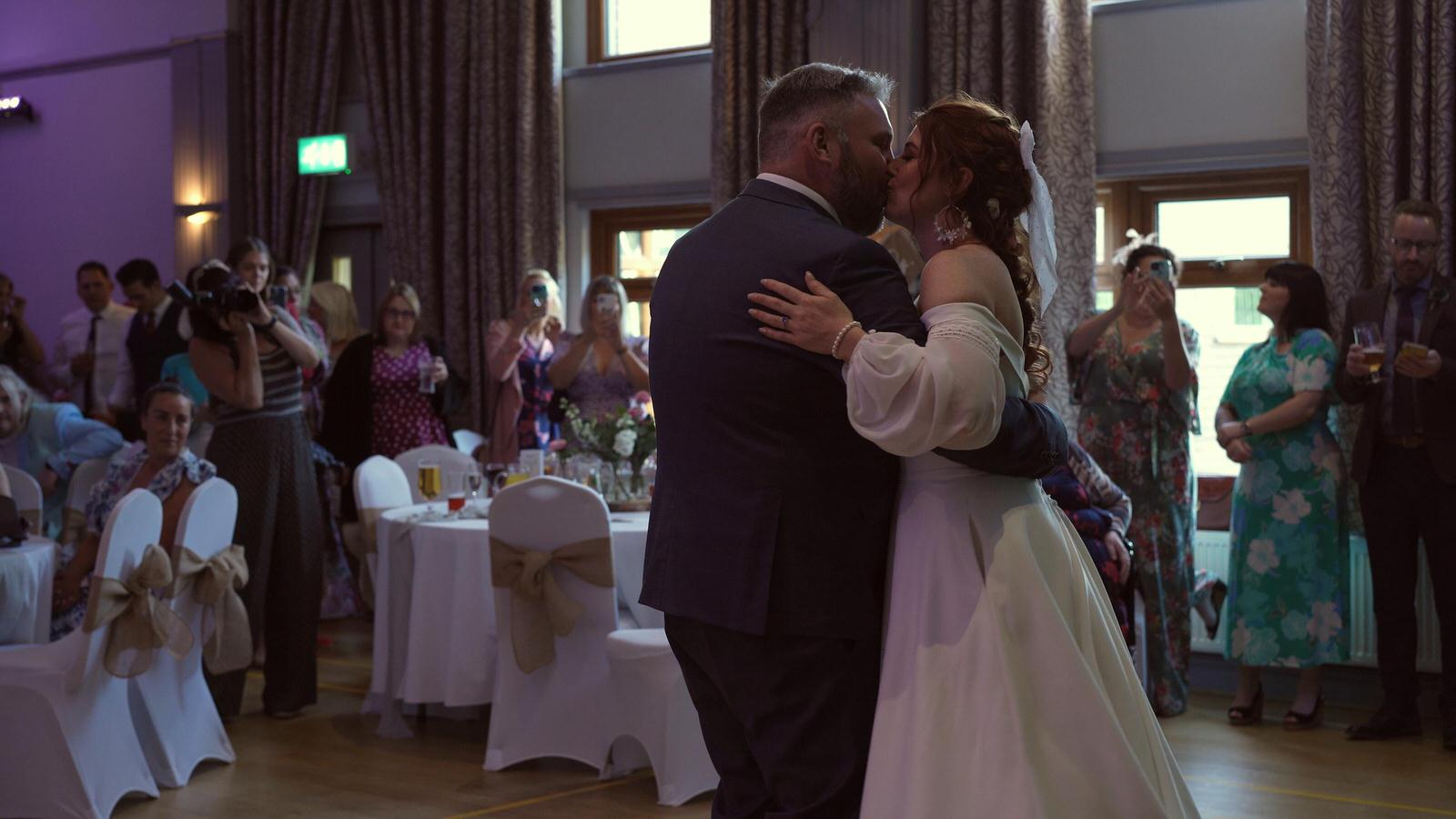 the couple kiss during first dance at Mawdesley village hall wedding