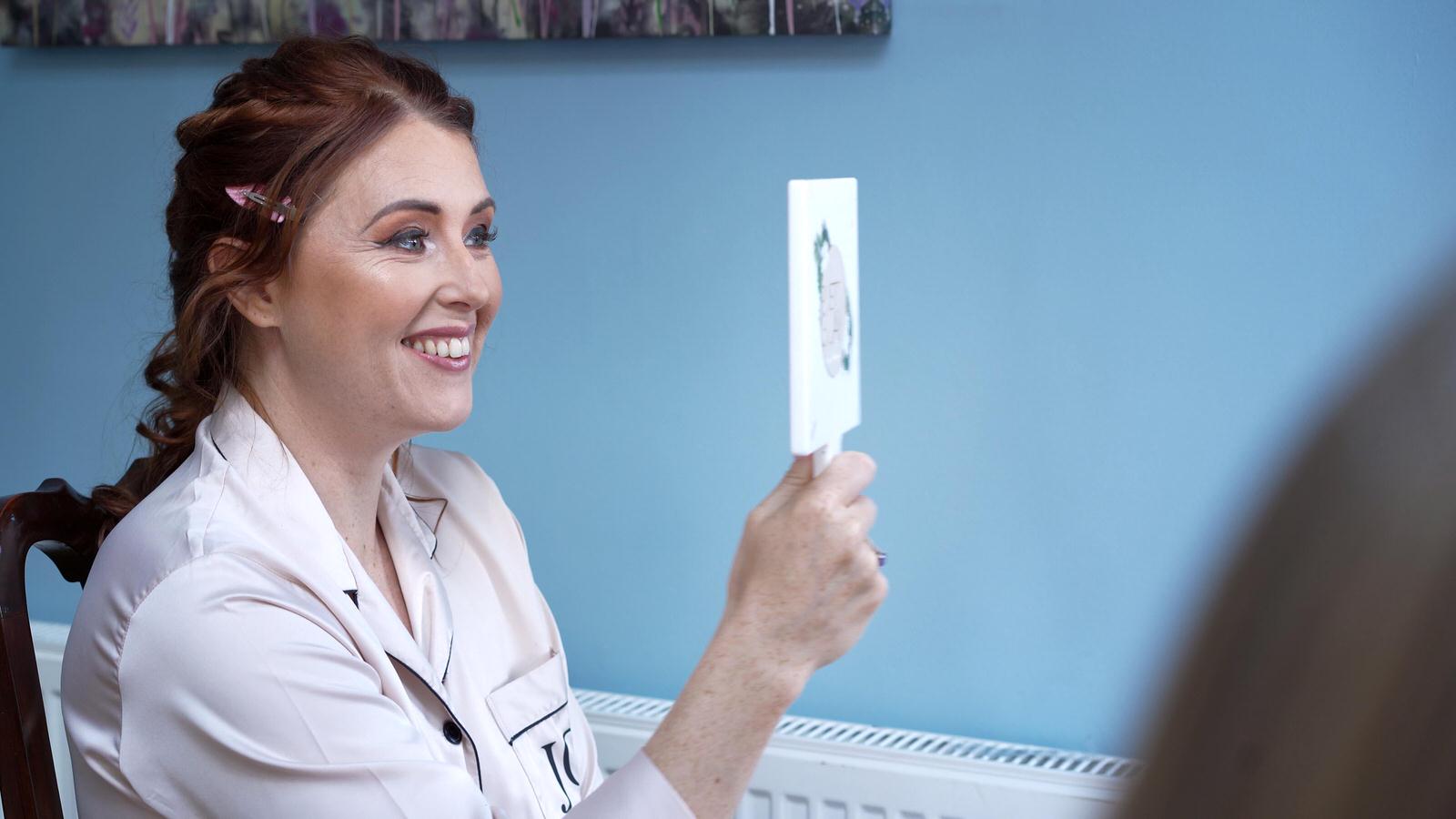 the bride smiles at her reflection