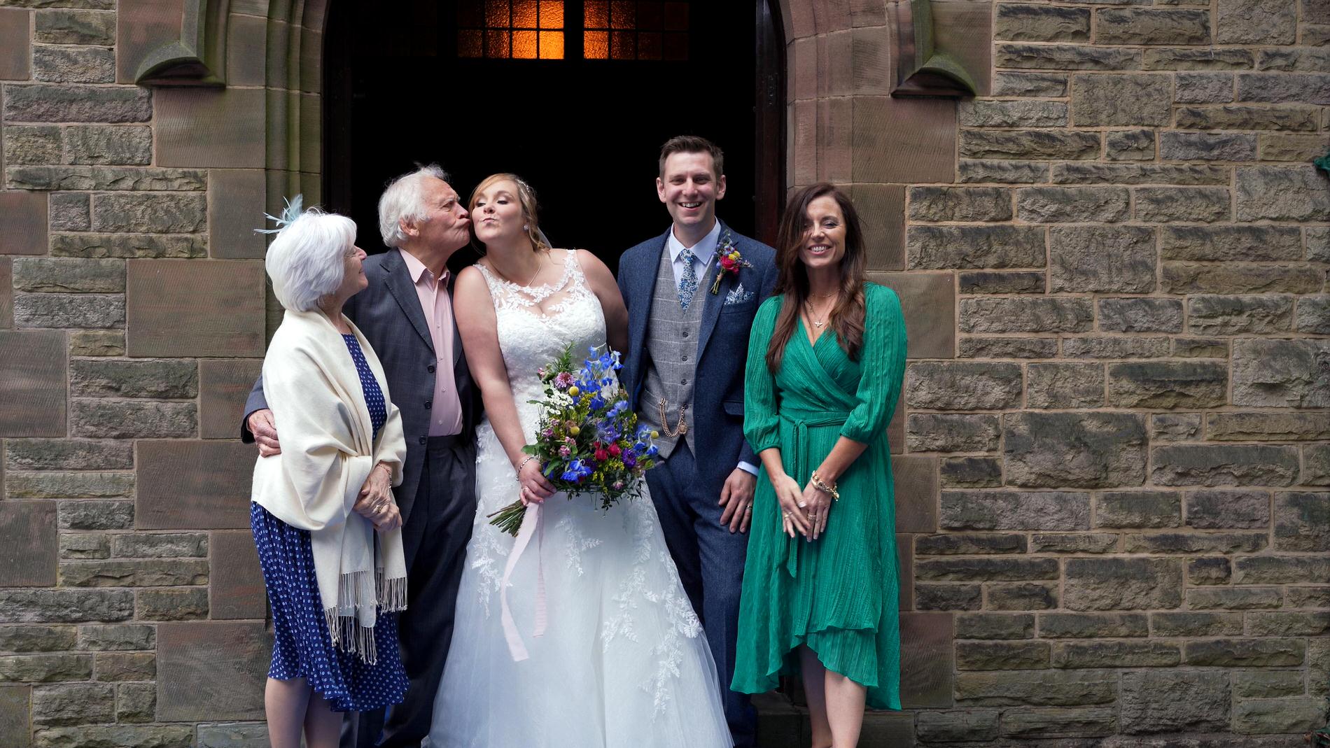 video still of fun group photo outside church