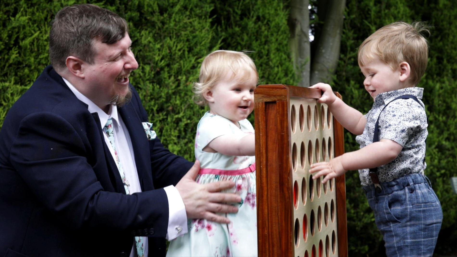 children play with wooden festival garden games