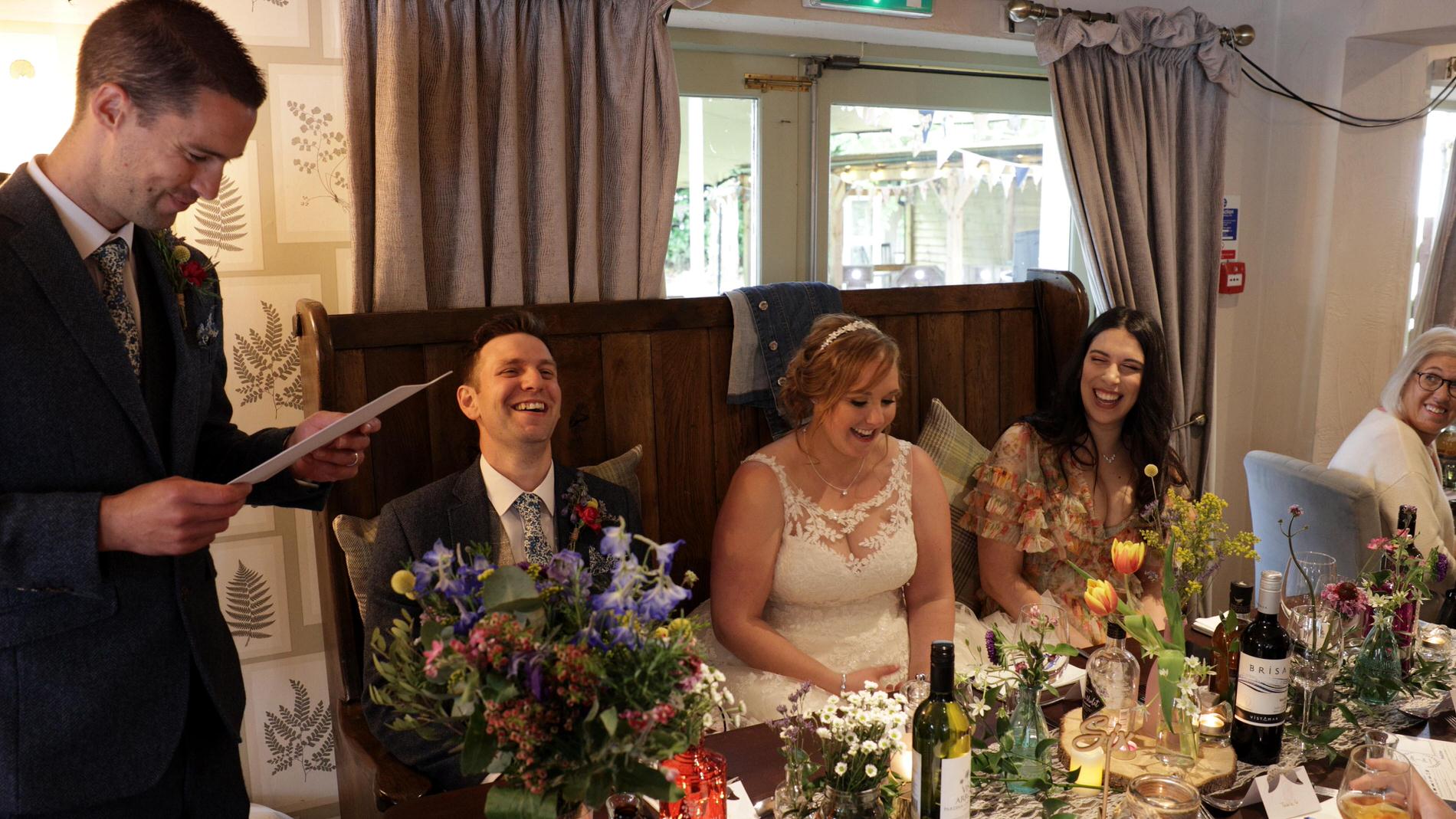 best man makes couple laugh during wedding speeches