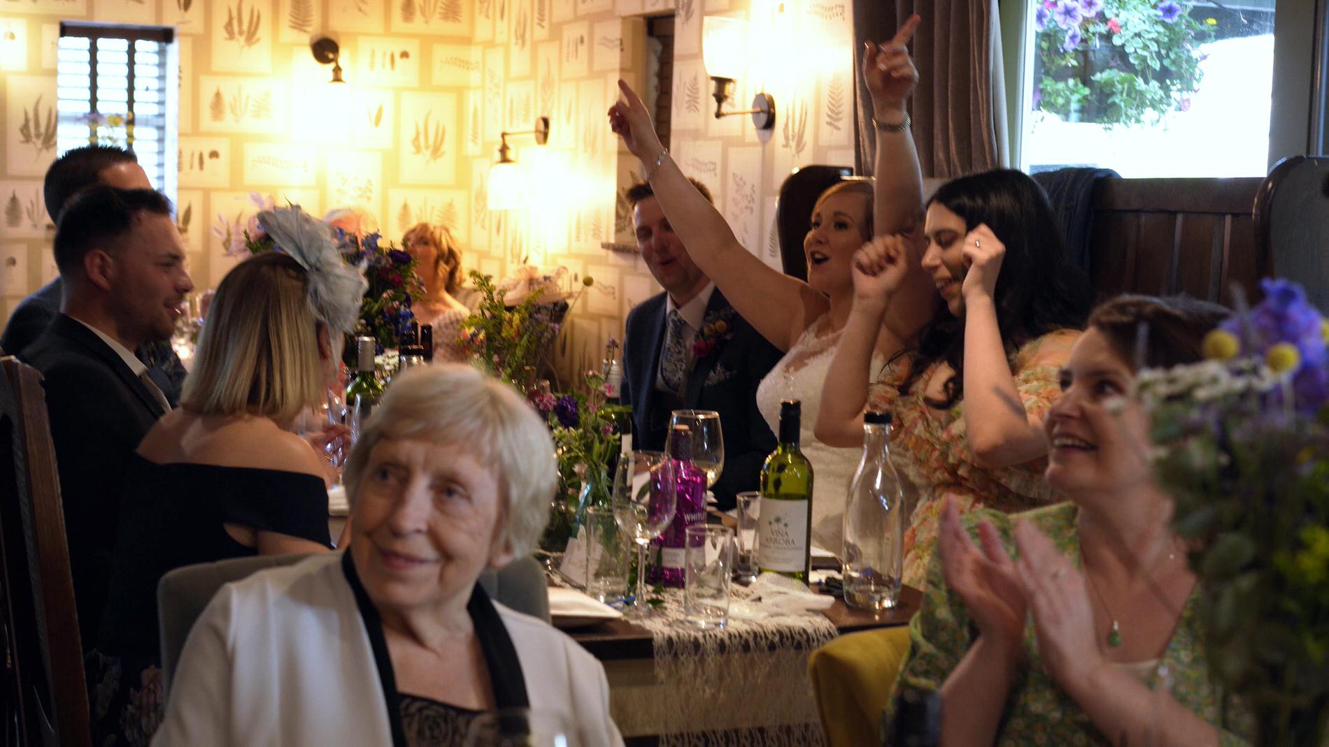 video still of guests singing along with surprise waiters