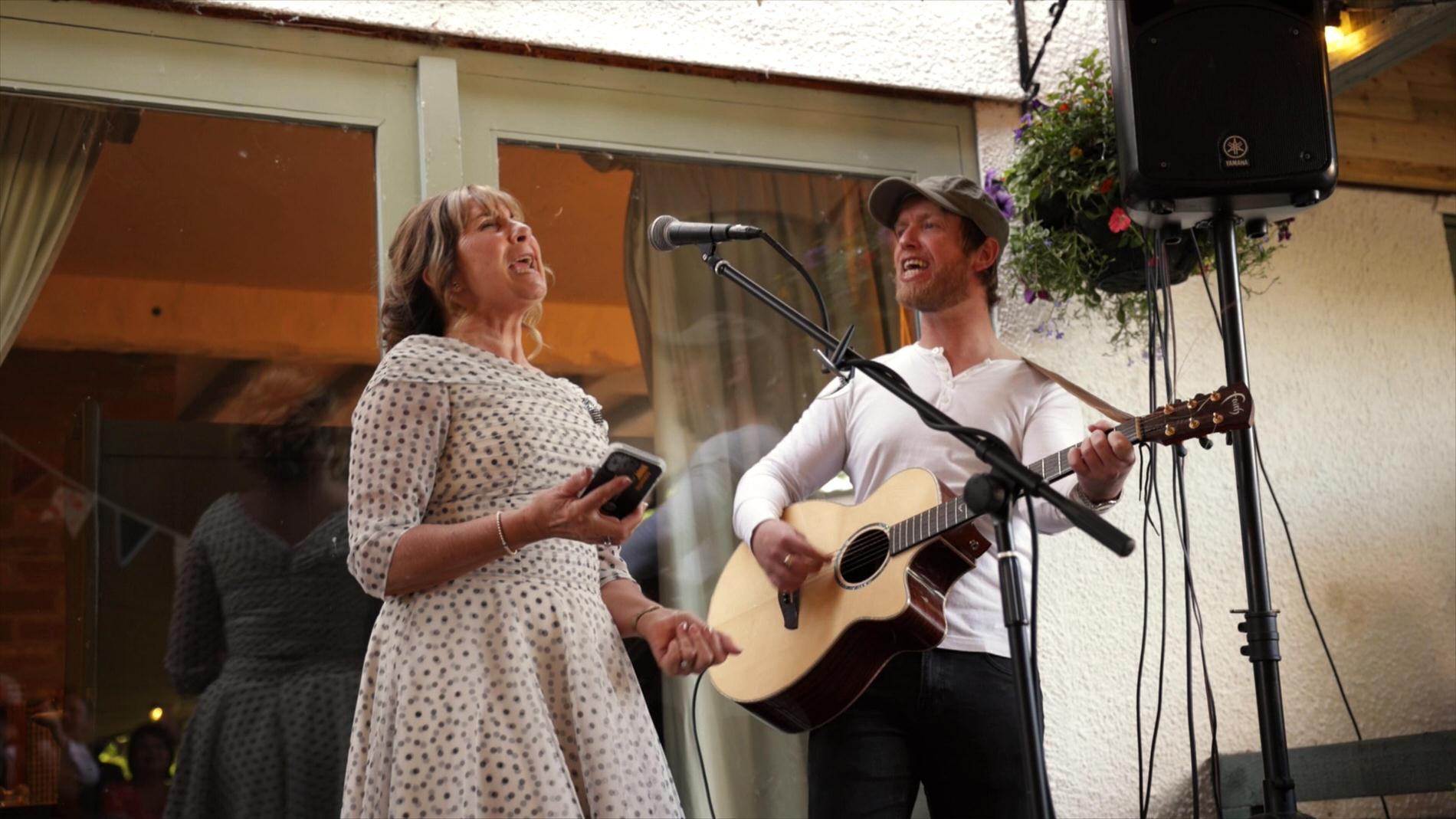 mother of the groom sings during wedding reception