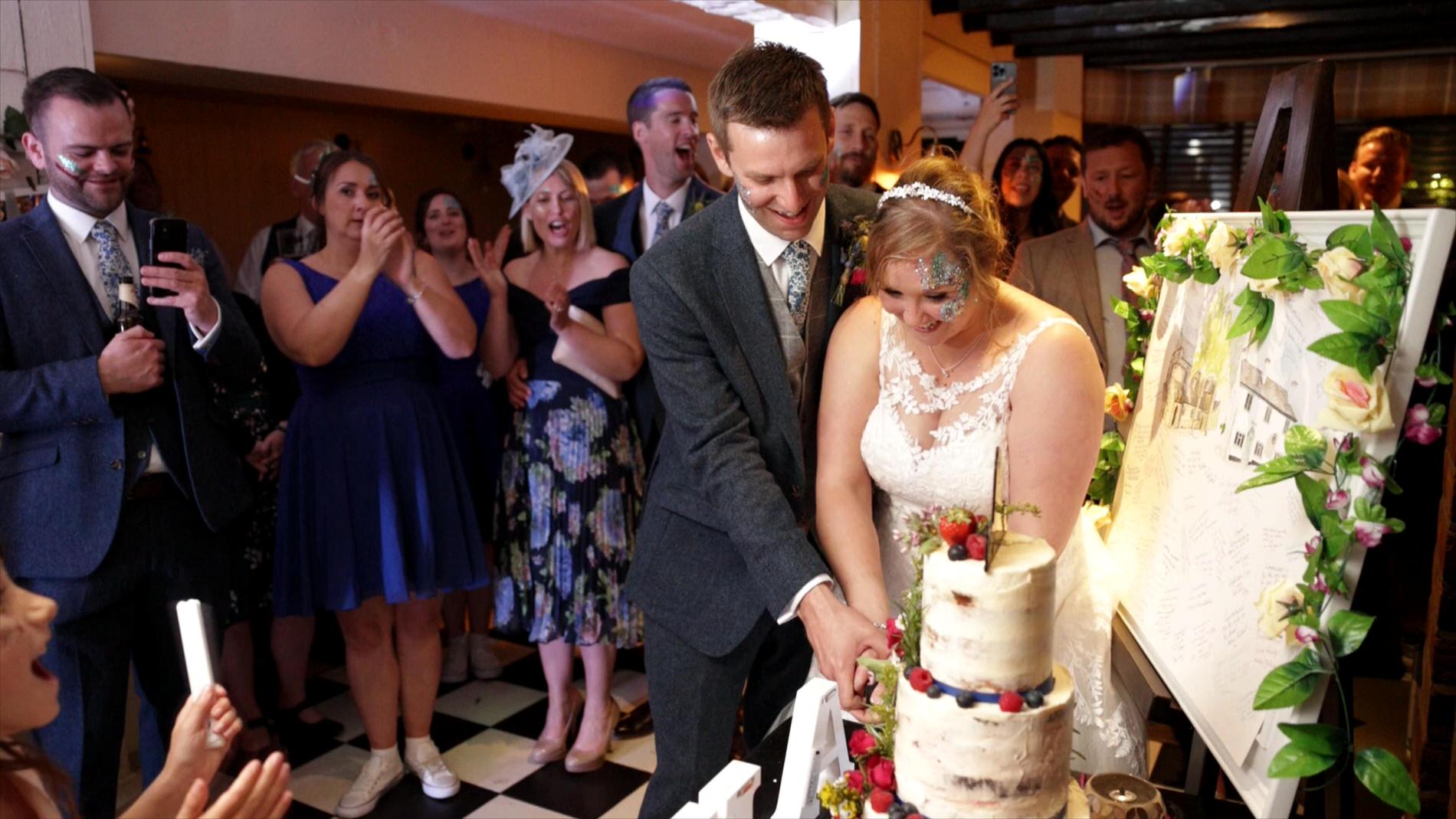couple cut their wedding cake at The Fox Roby Mill