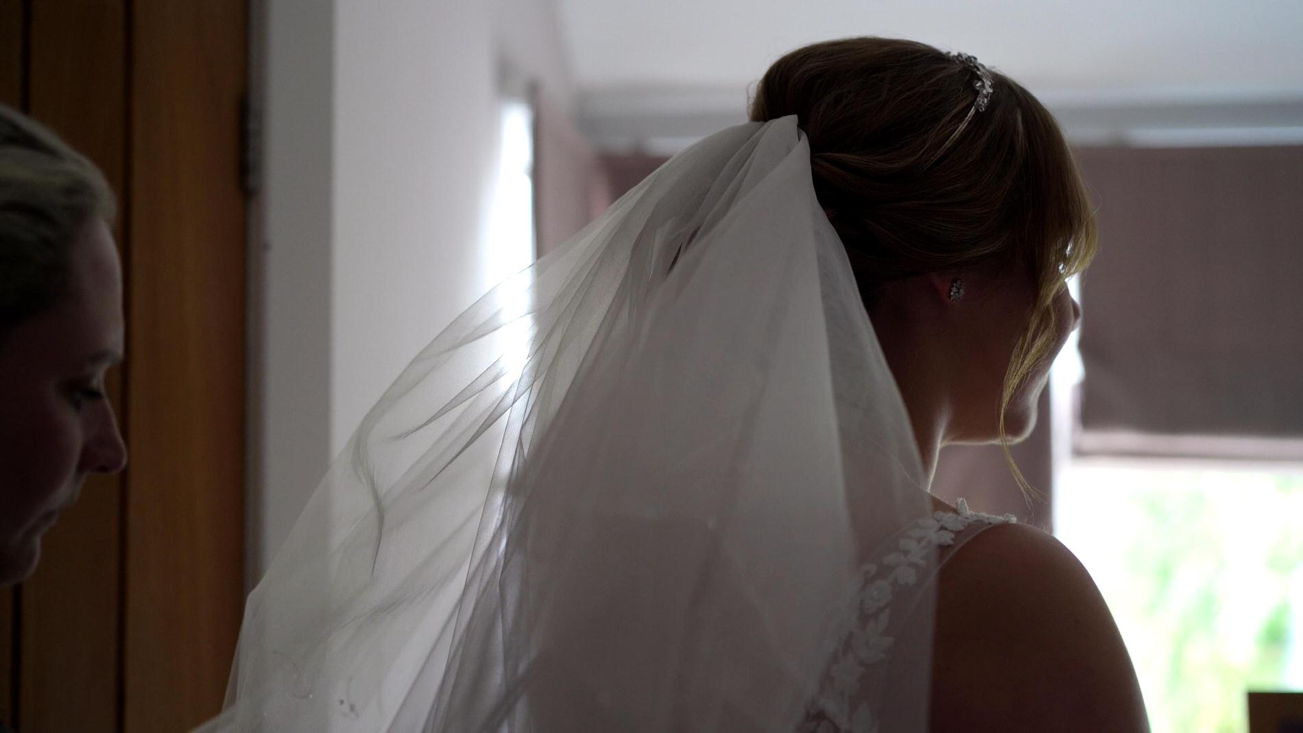 bride gets veil put on