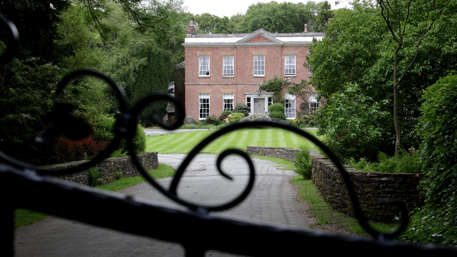 front of Rivington hall barn manor house through gate