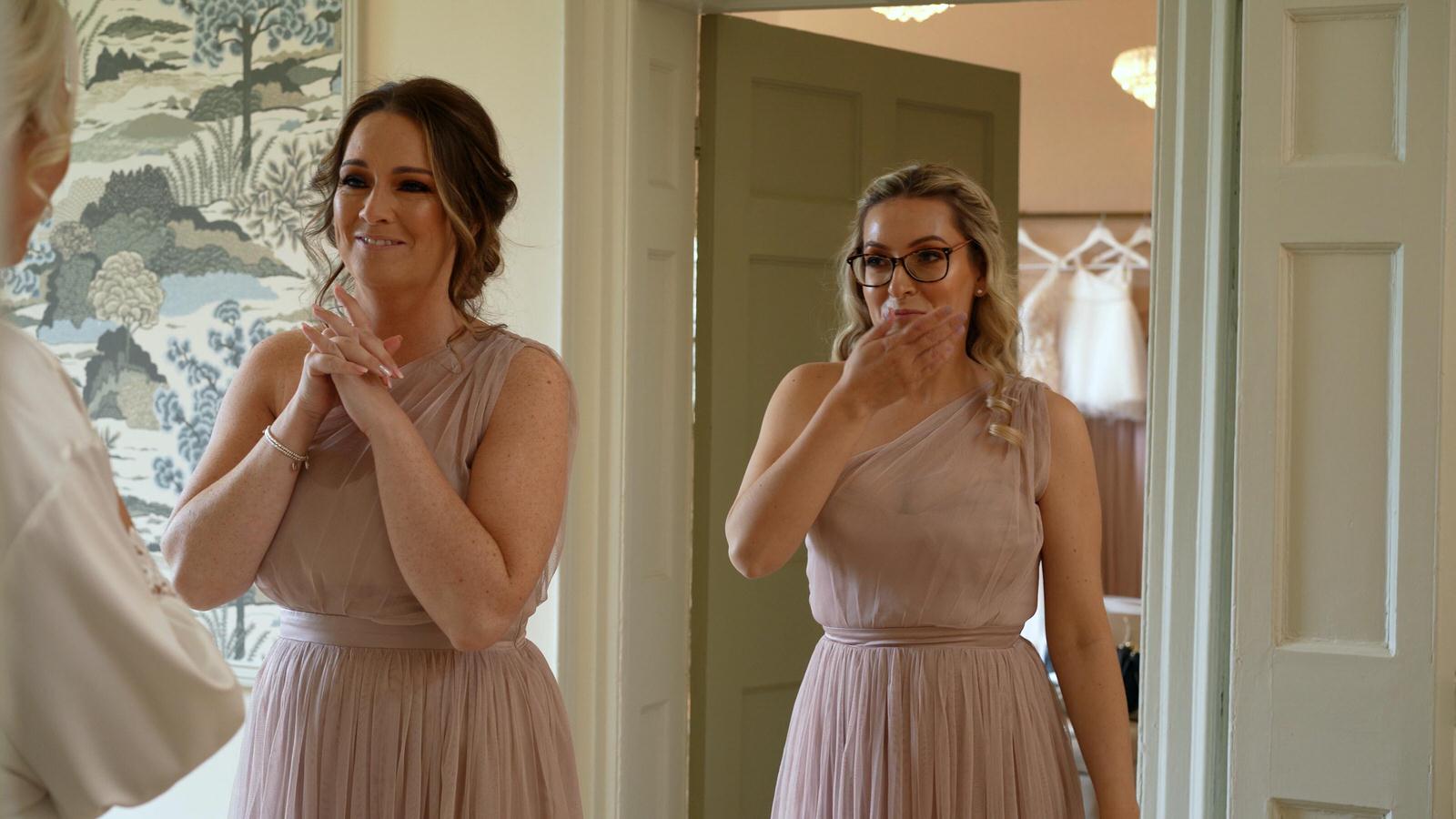 video still of bridesmaids reaction to brides makeup