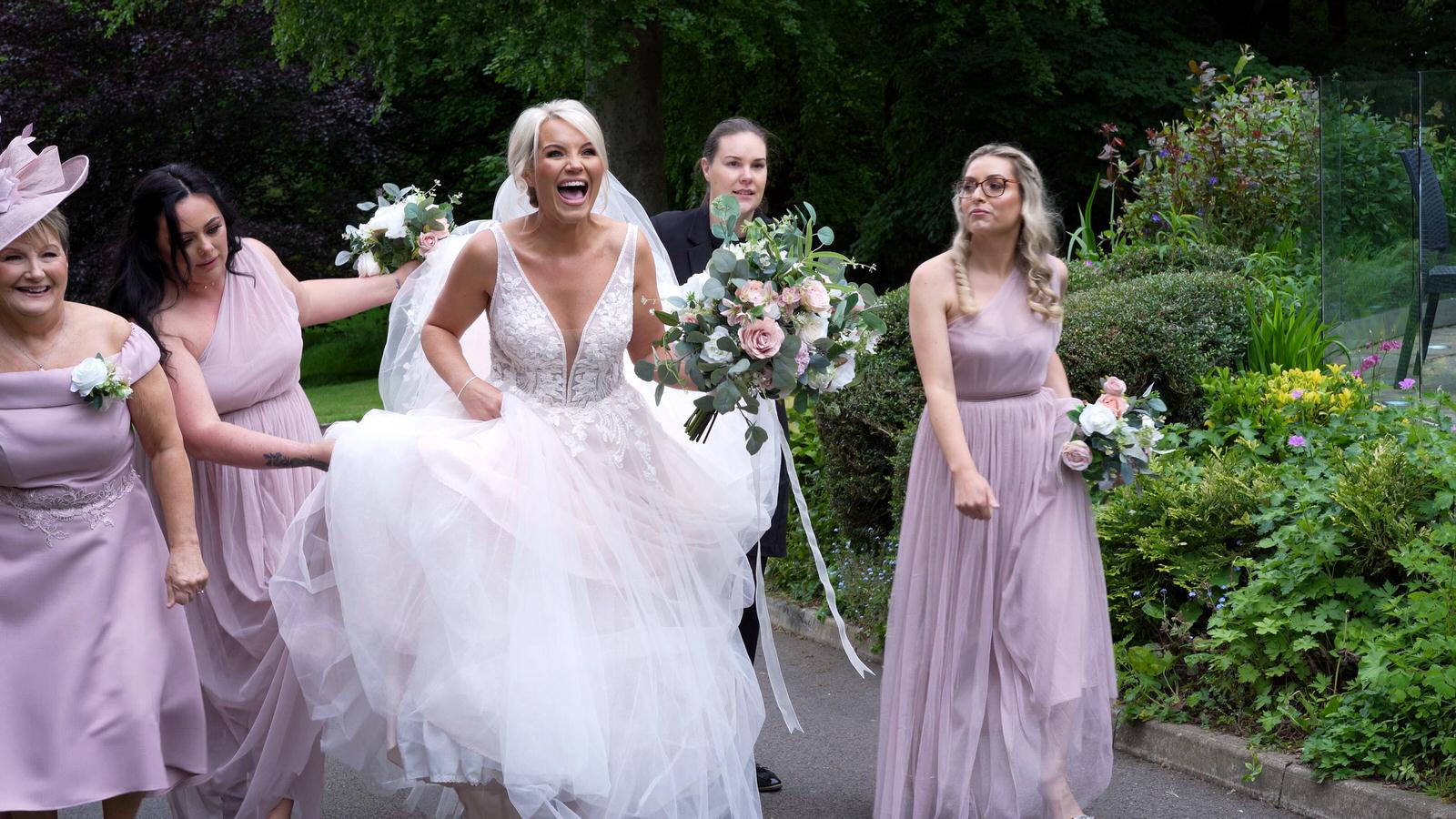 bride laughs with Rivington hall barn staff