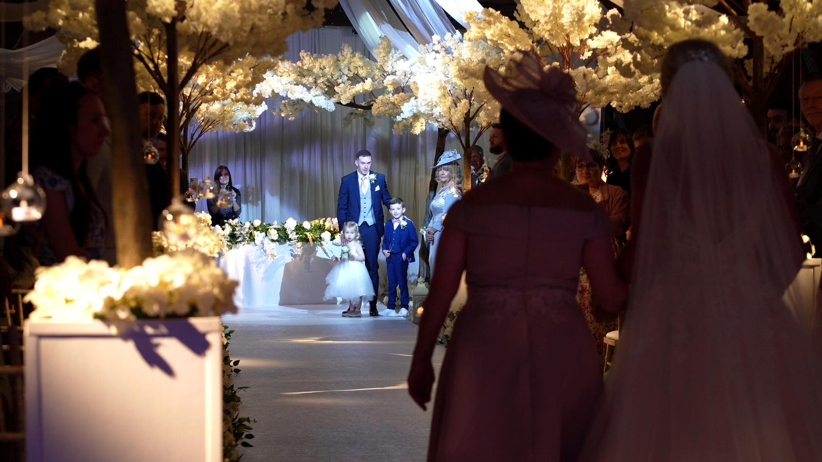 video still of children waiting with dad for the bride
