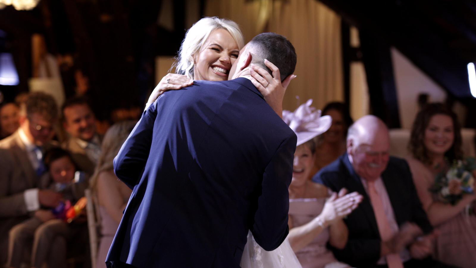 bride and groom hug during wedding ceremony