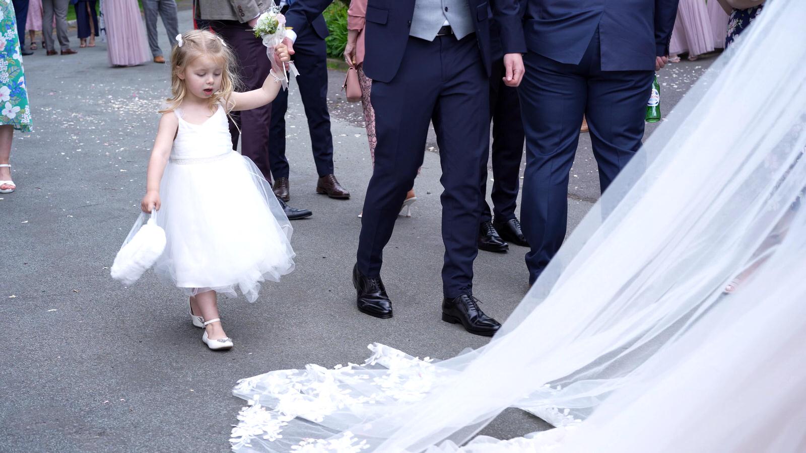 flower girl follows the brides train