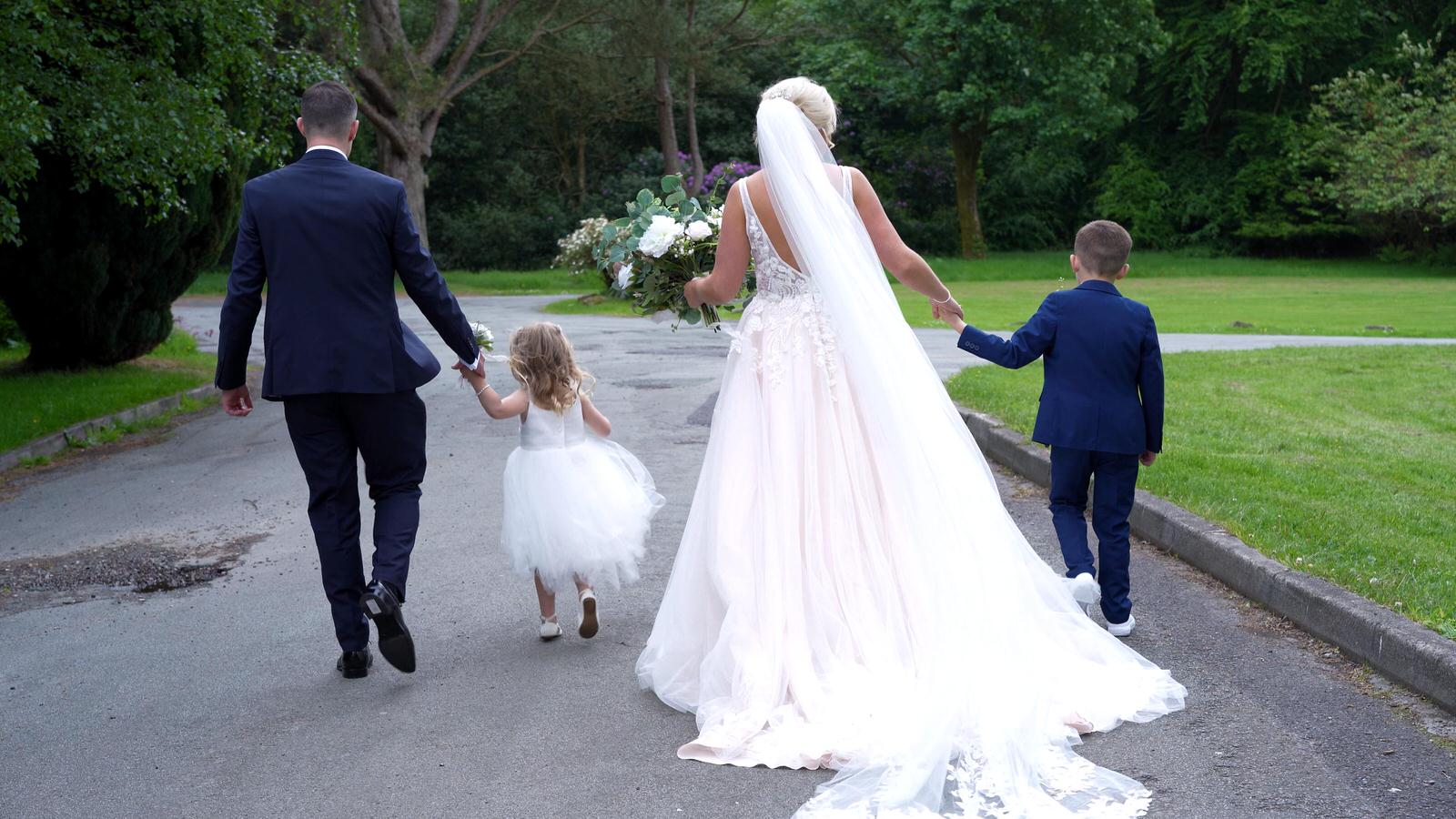 video still of family walking around Rivington hall barn