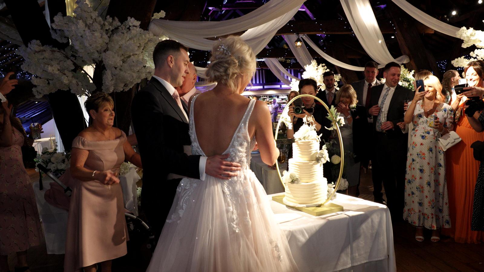 couple cut their wedding cake at Rivington hall barn