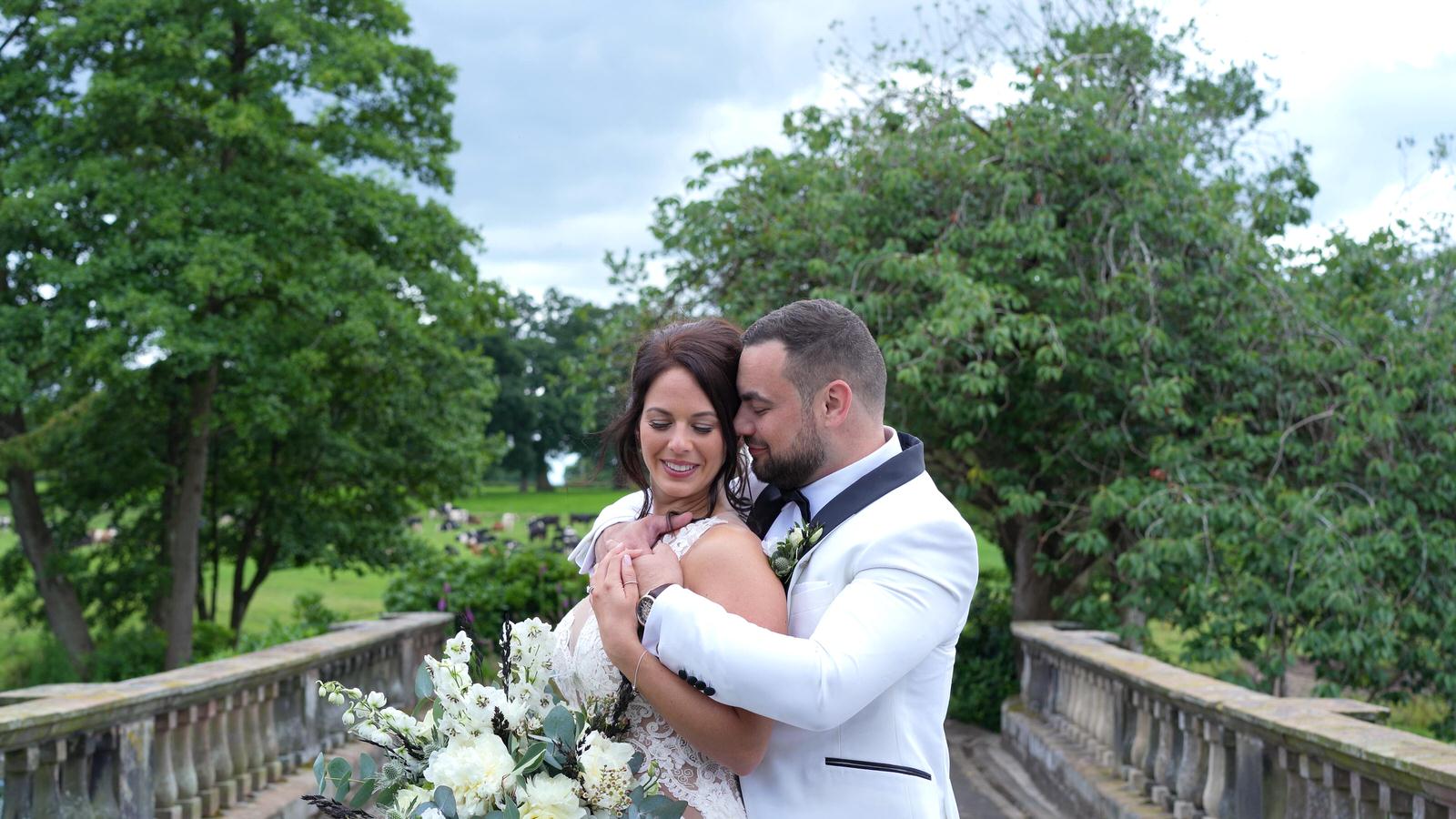 stylish couple pose for photographer and videographer at Capesthorne