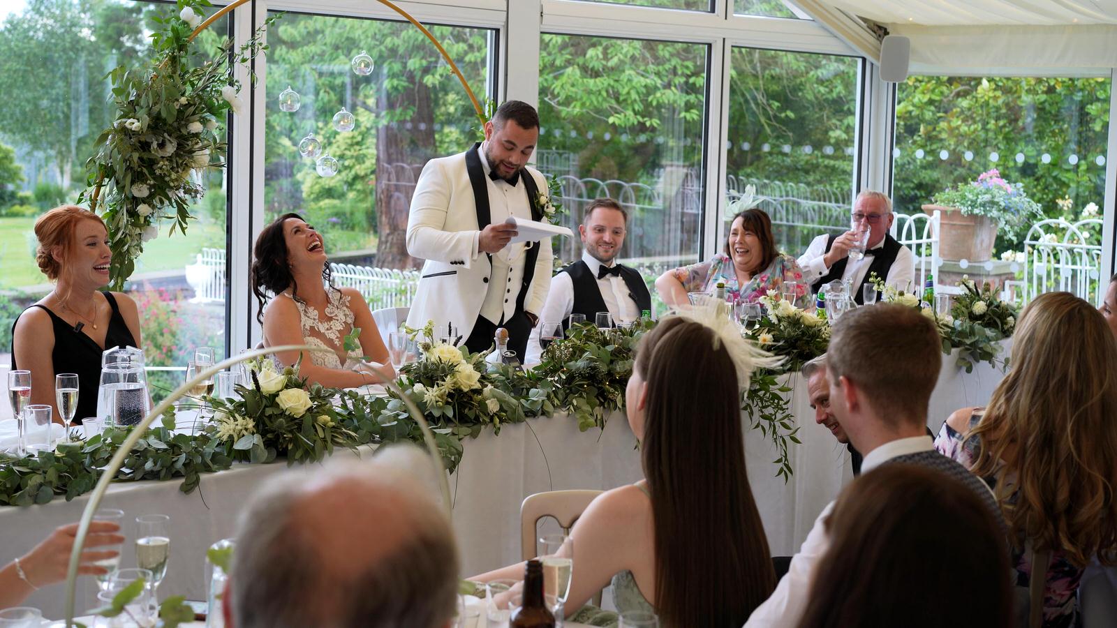 groom makes bride laugh during speech