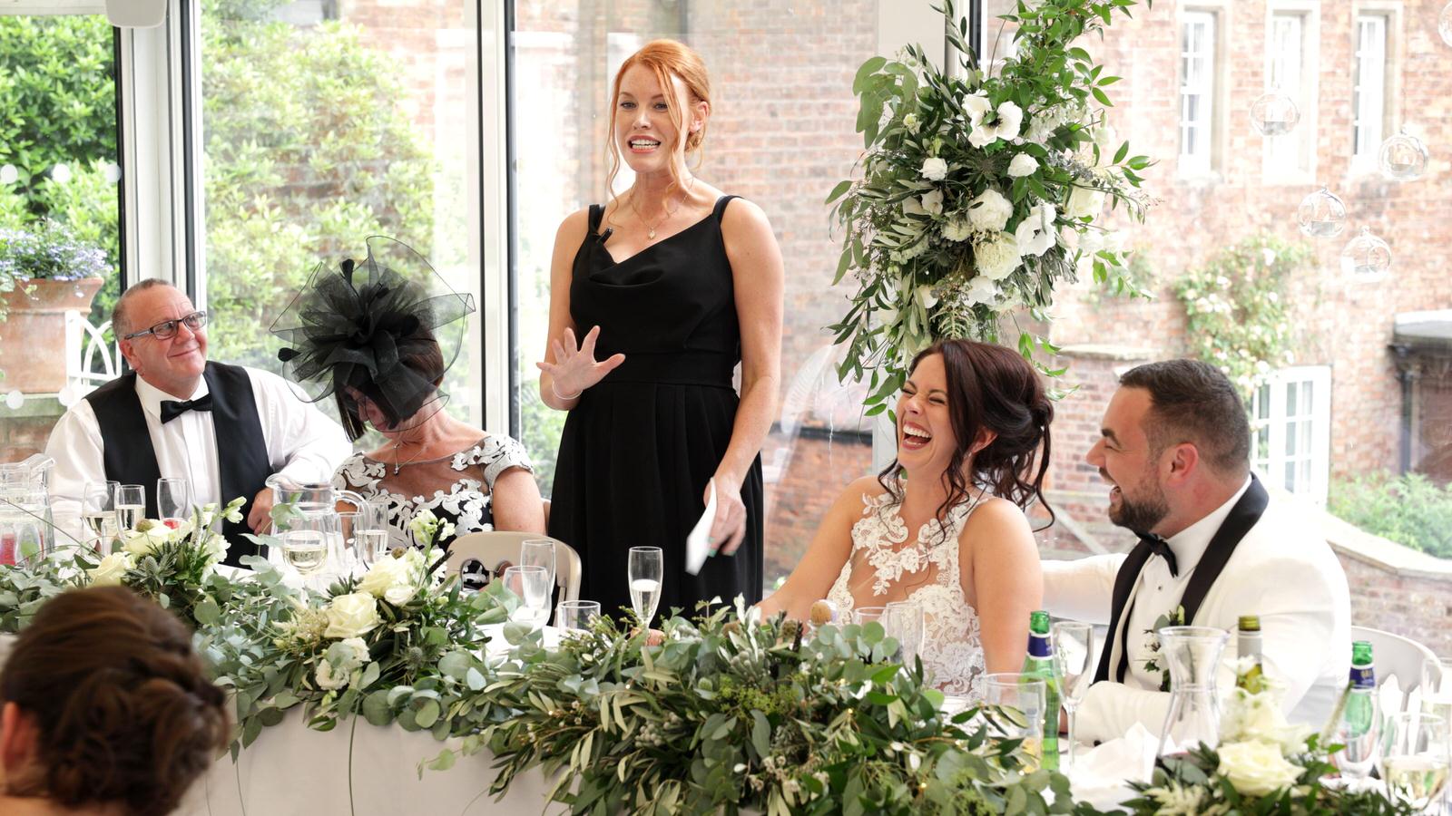 maid of honour stands for her speech