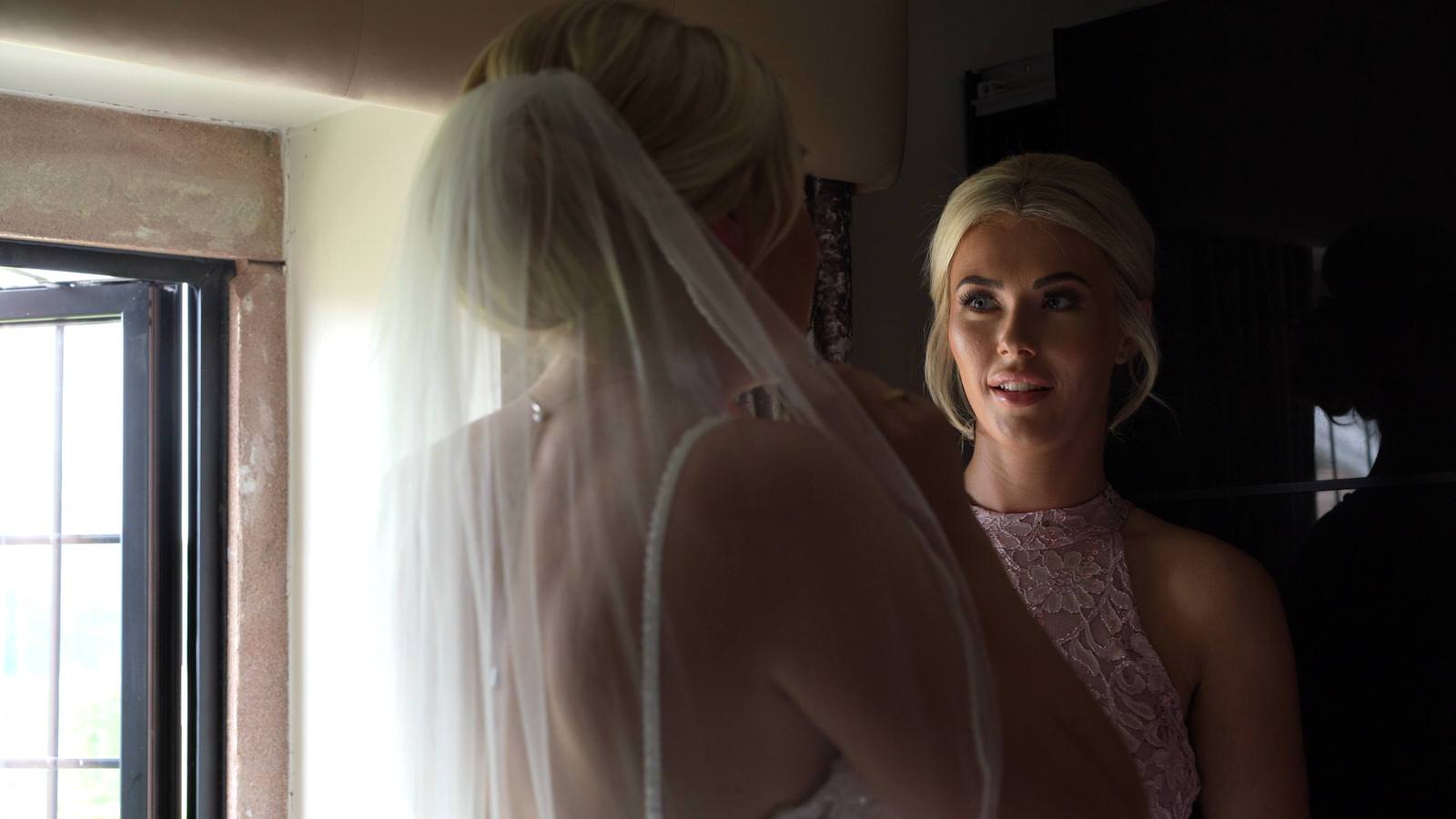 video still of bridesmaid smiling at bride